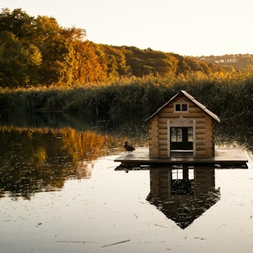 A picturesque duck house floating on the lake at Parcul Valea Morilor, Chisinau, beautifully reflected in the calm water during golden hour. , License Type: media, Download Time: 2025-02-25T20:40:24.000Z, User: katelyn.perry_lonelyplanet, Editorial: false, purchase_order: 65050 - Digital Destinations and Articles, job: wip, client: wip, other: Katelyn Perry