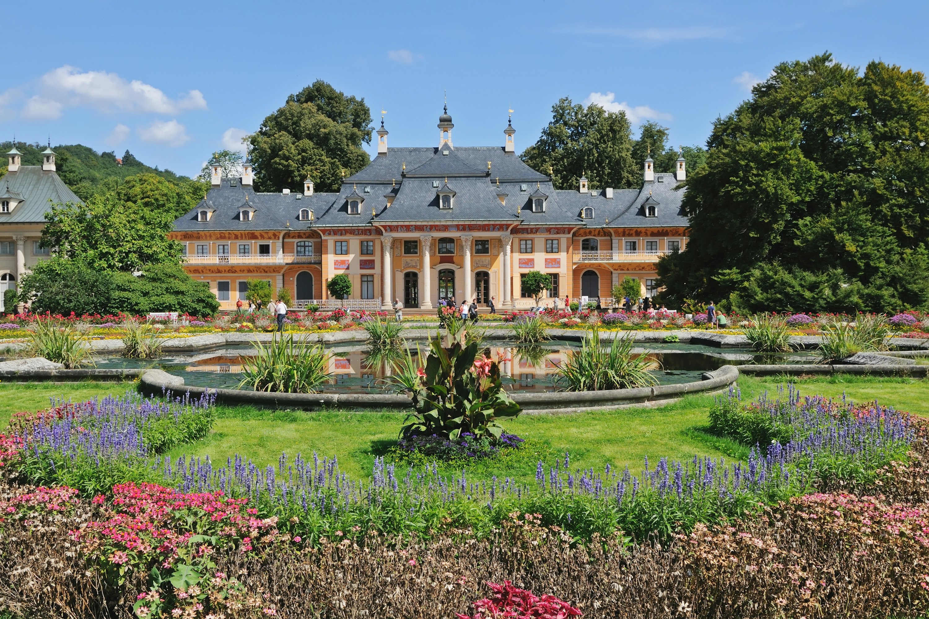 Pillnitz Castle in Saxony near Dresden, Germany, surrounded by flowers.