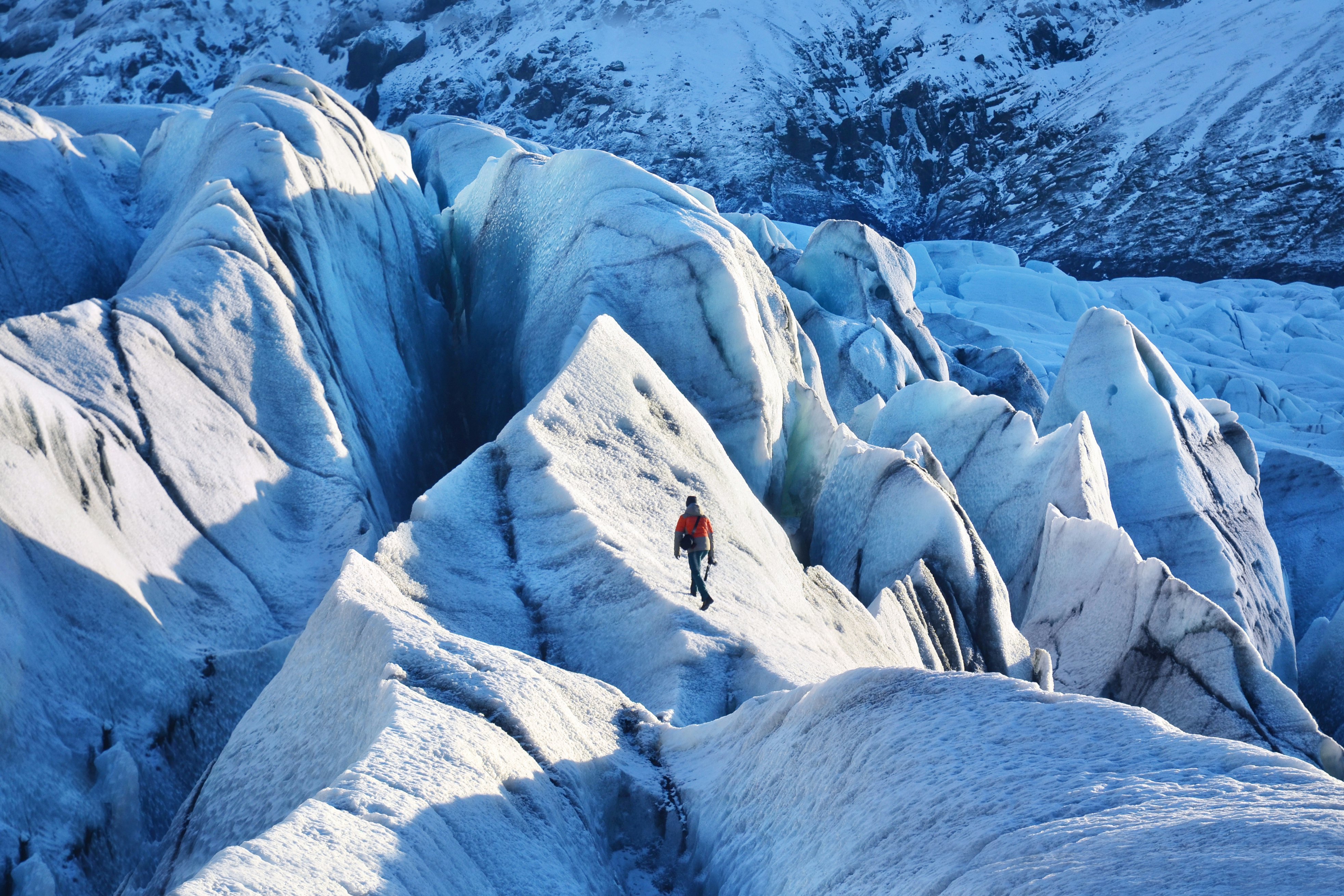 Man walking on the Vatna Glacier at Vatnajökull National Park in iceland.