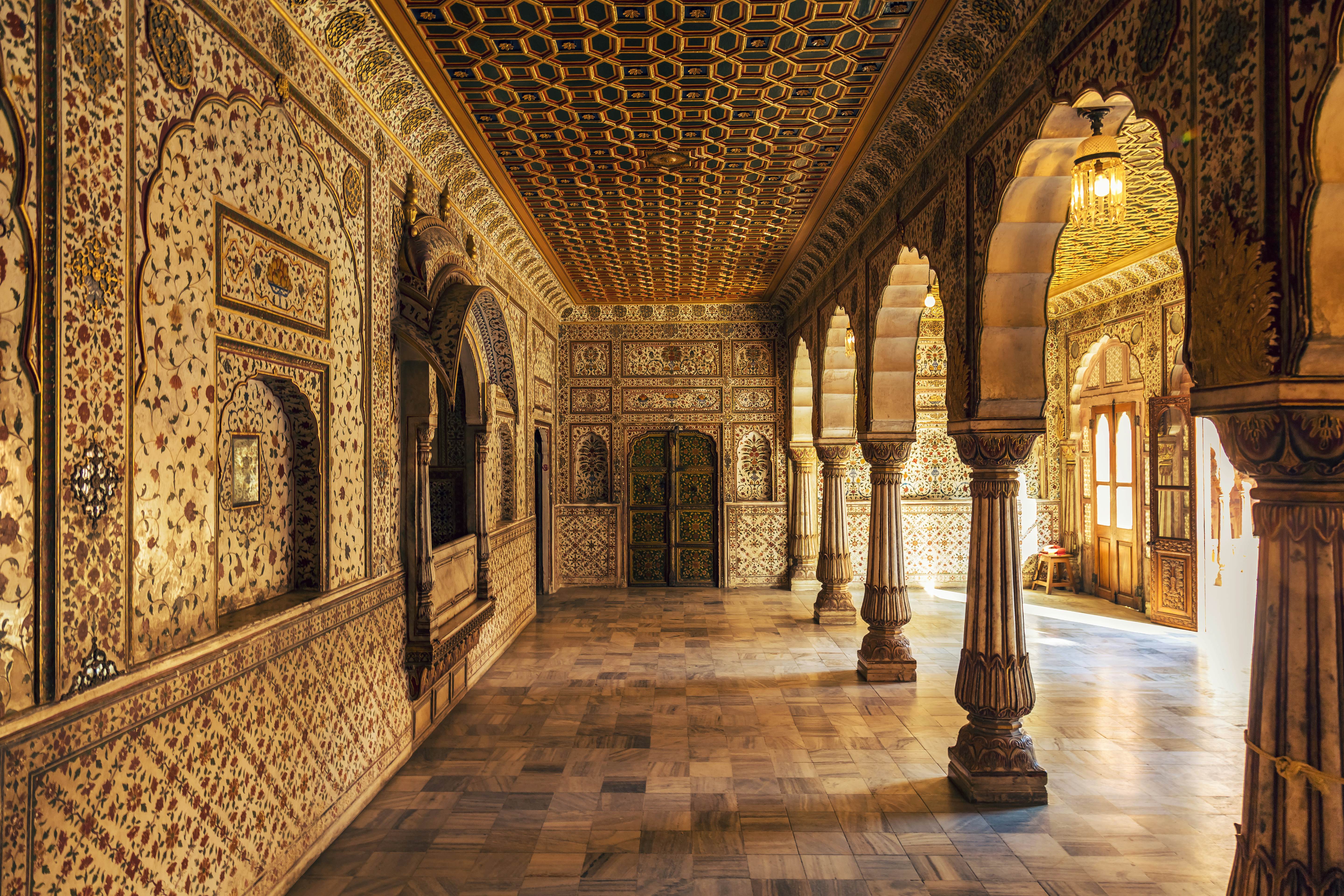 Ornate interior walls of a large room with supporting columns