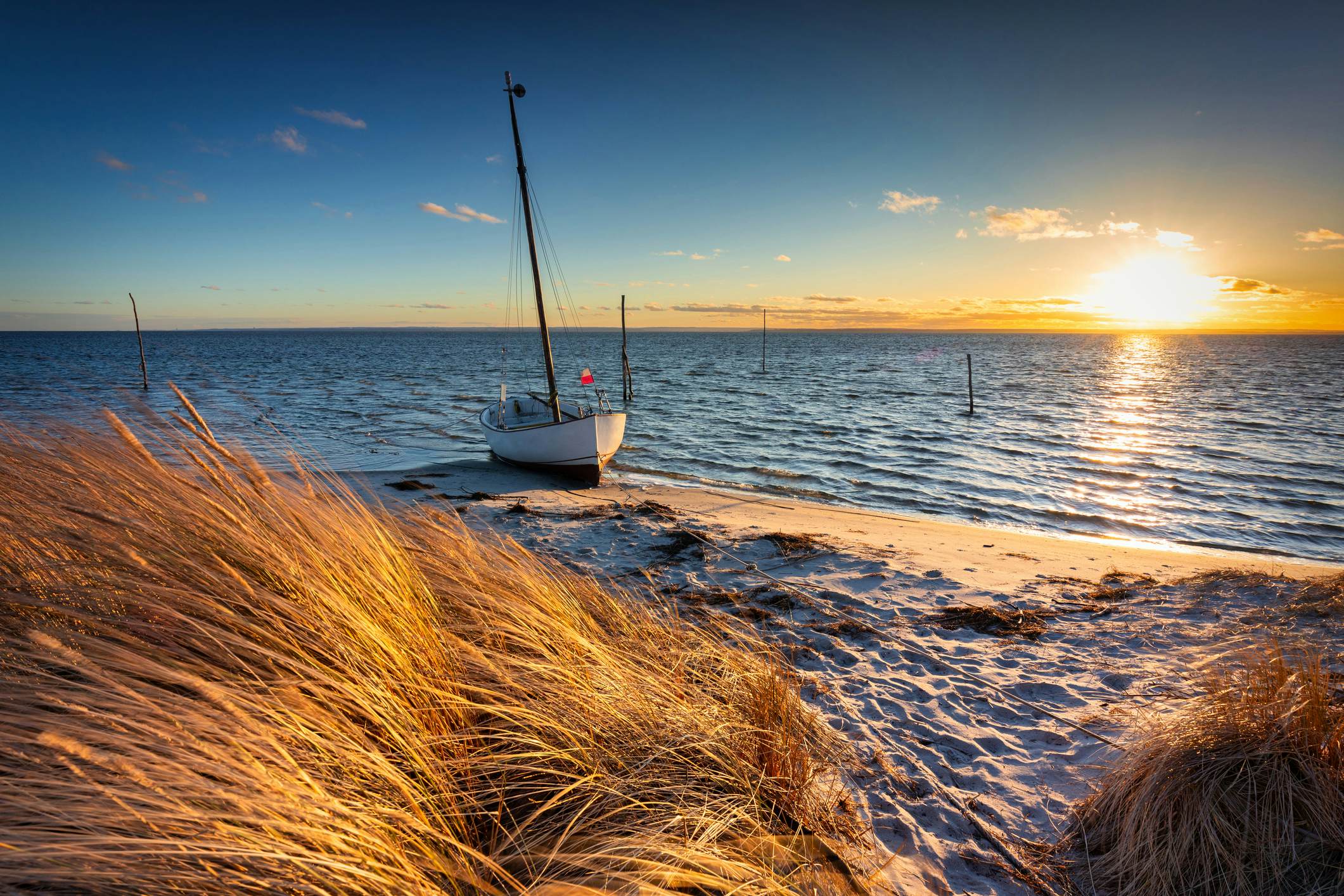 A boat on a Baltic beach at sunset in Kuznica, Hel Peninsula, Poland.