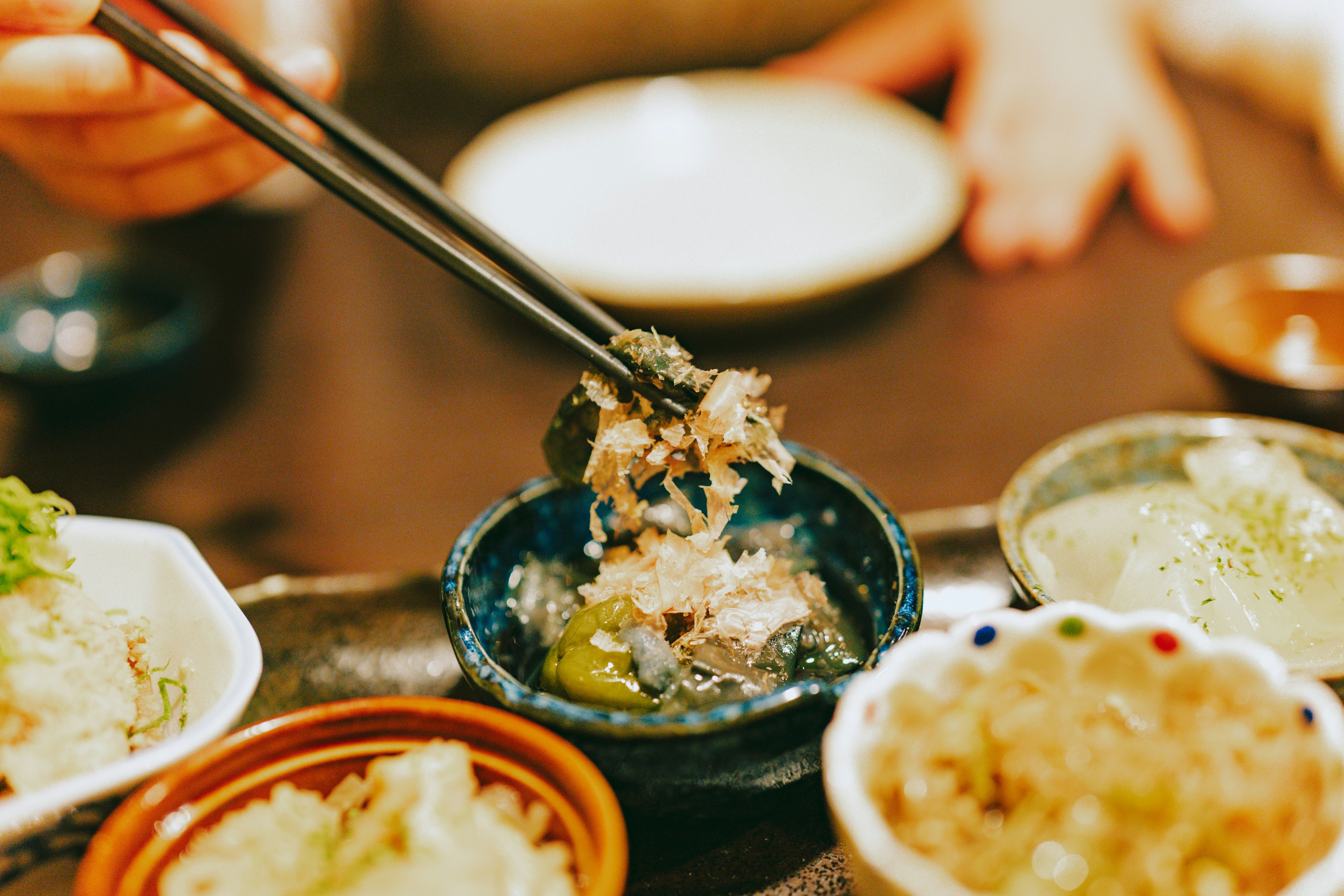 A tray with tiny round dishes each loaded with a different combination of foods and textures.