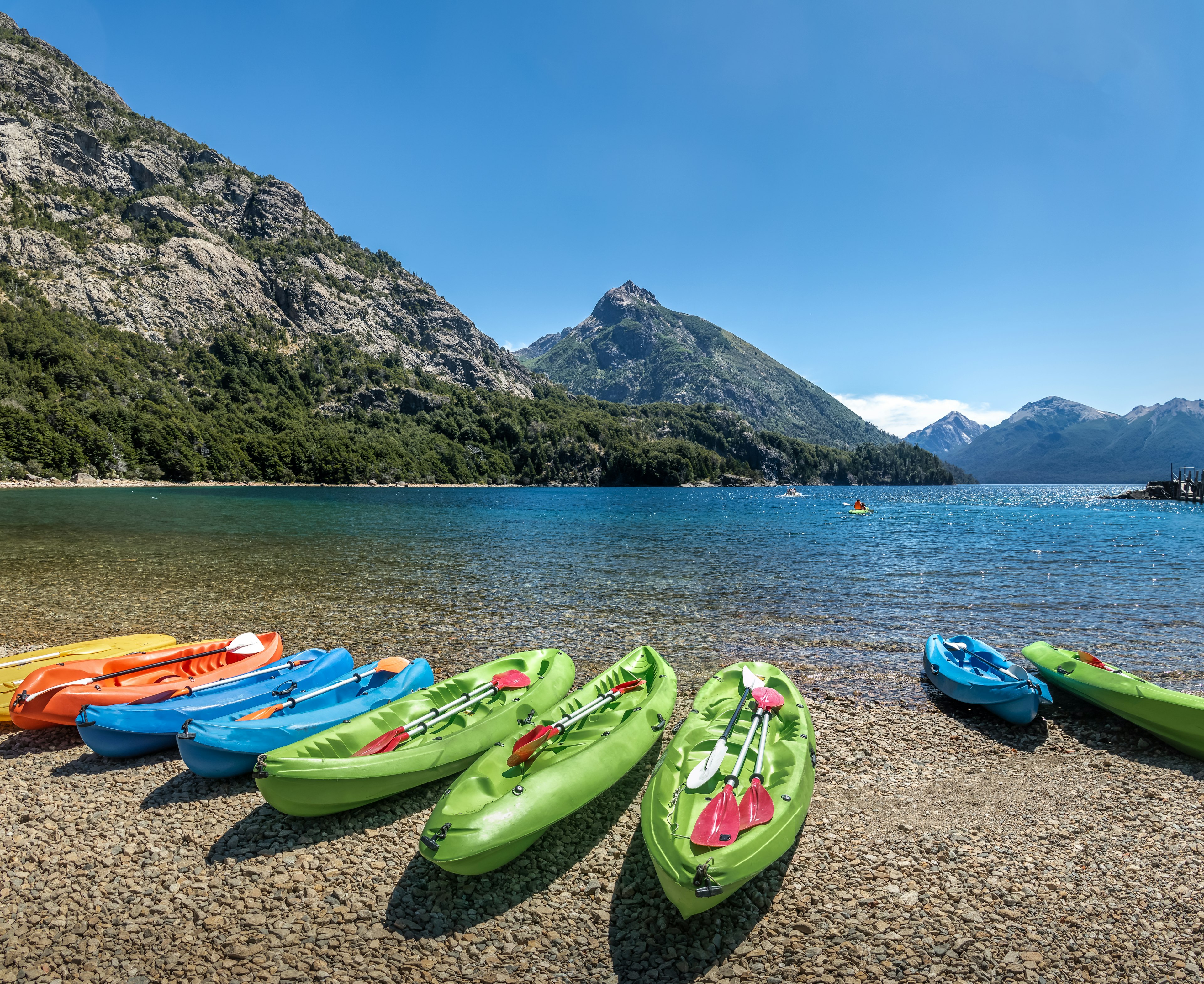 Colorful Kayaks in a lake surrounded by mountains at Bahia Lopez in Circuito Chico - Bariloche, Patagonia, Argentina License Type: media Download Time: 2024-01-05T08:09:43.000Z User: mvm_lonelyplanet Is Editorial: No purchase_order:
