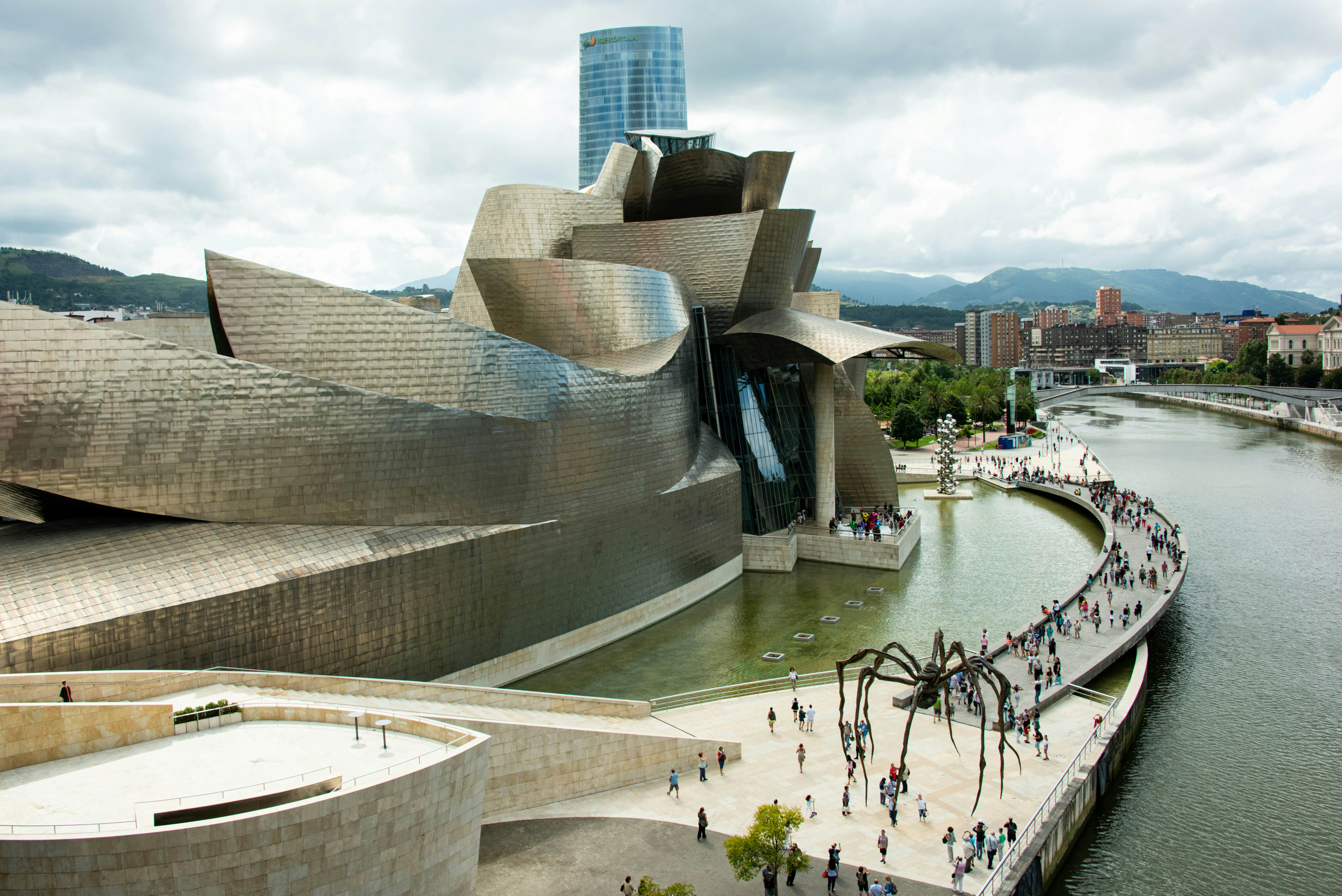 The Guggenheim museum for the former industrial city of Bilbao with The Spider sculpture by Louise Bourgeois in the foreground.