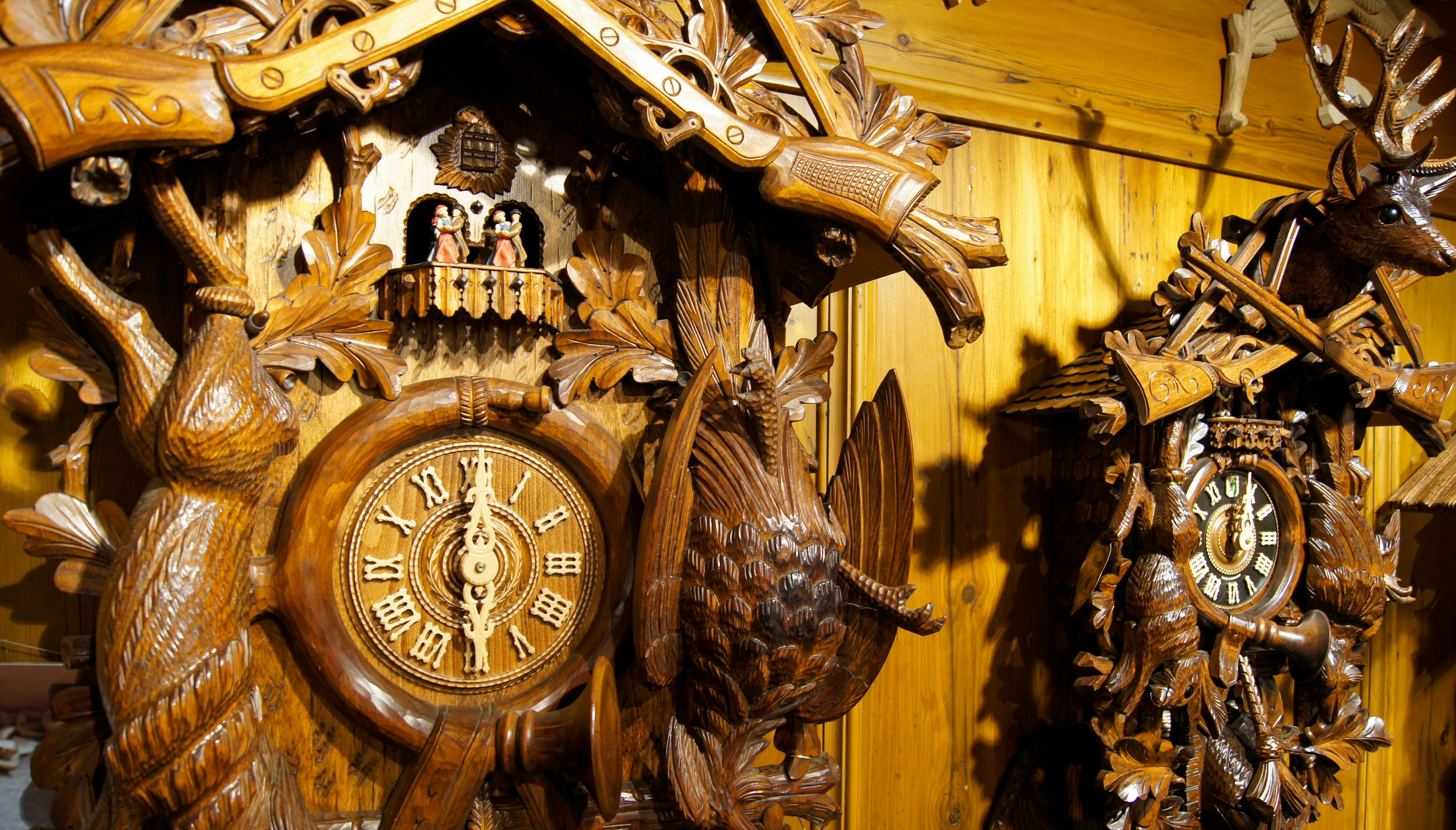 Two wooden, handcarved cuckoo clocks on display in Triberg in Germany.