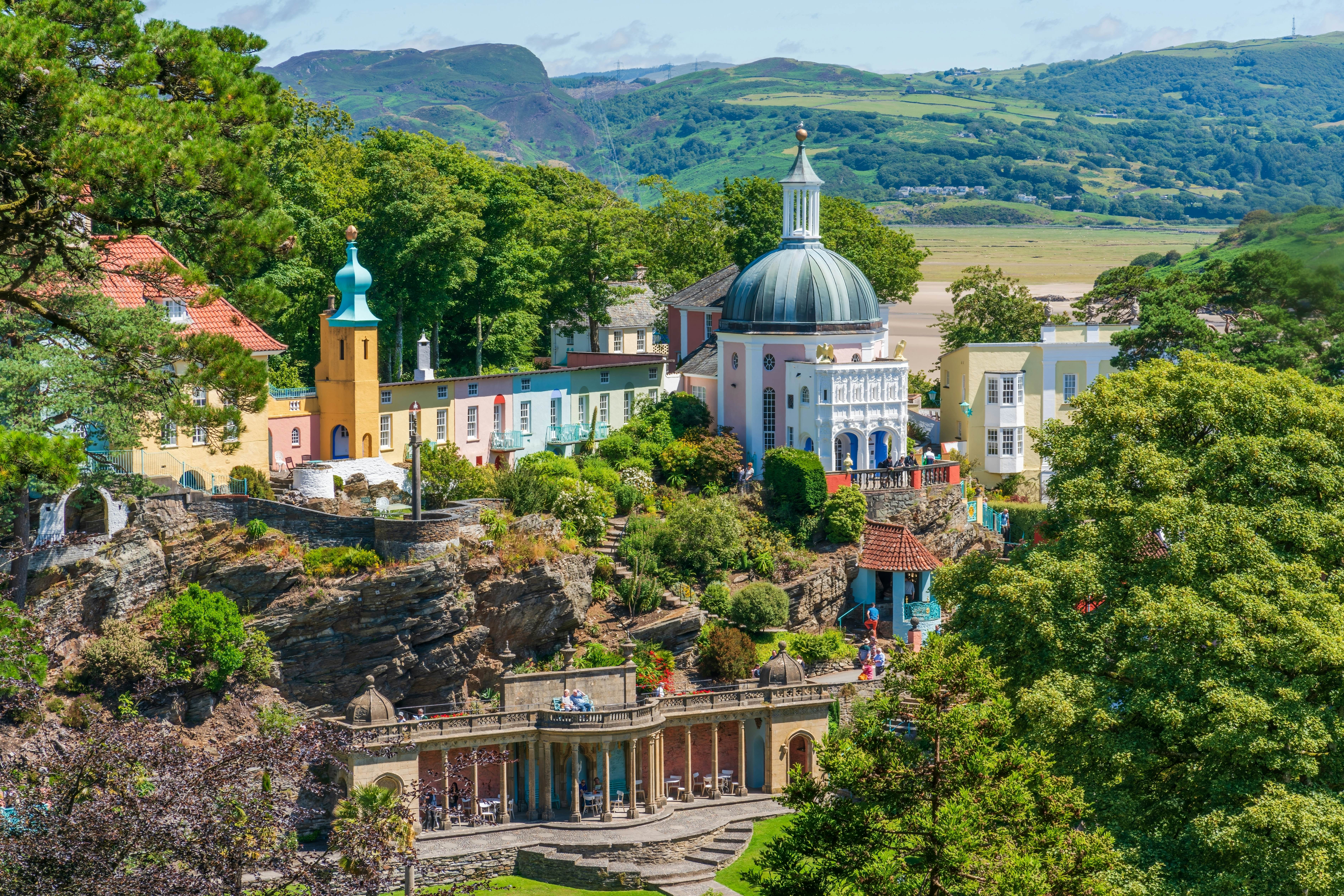 Pastel domed and turreted buildings in ornate landscaped gardens