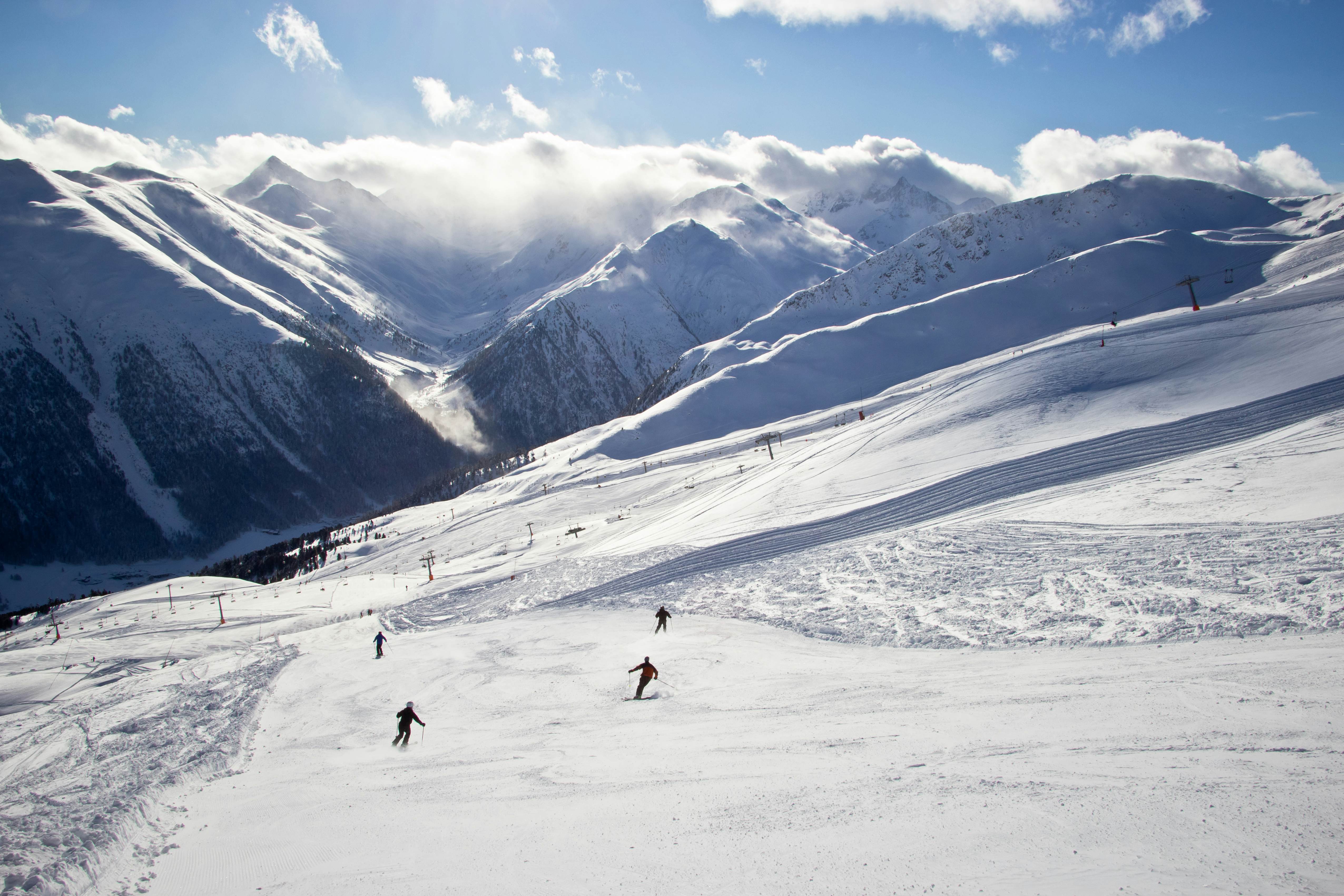 Snow-covered slopes with skiers in Livigno, Italy