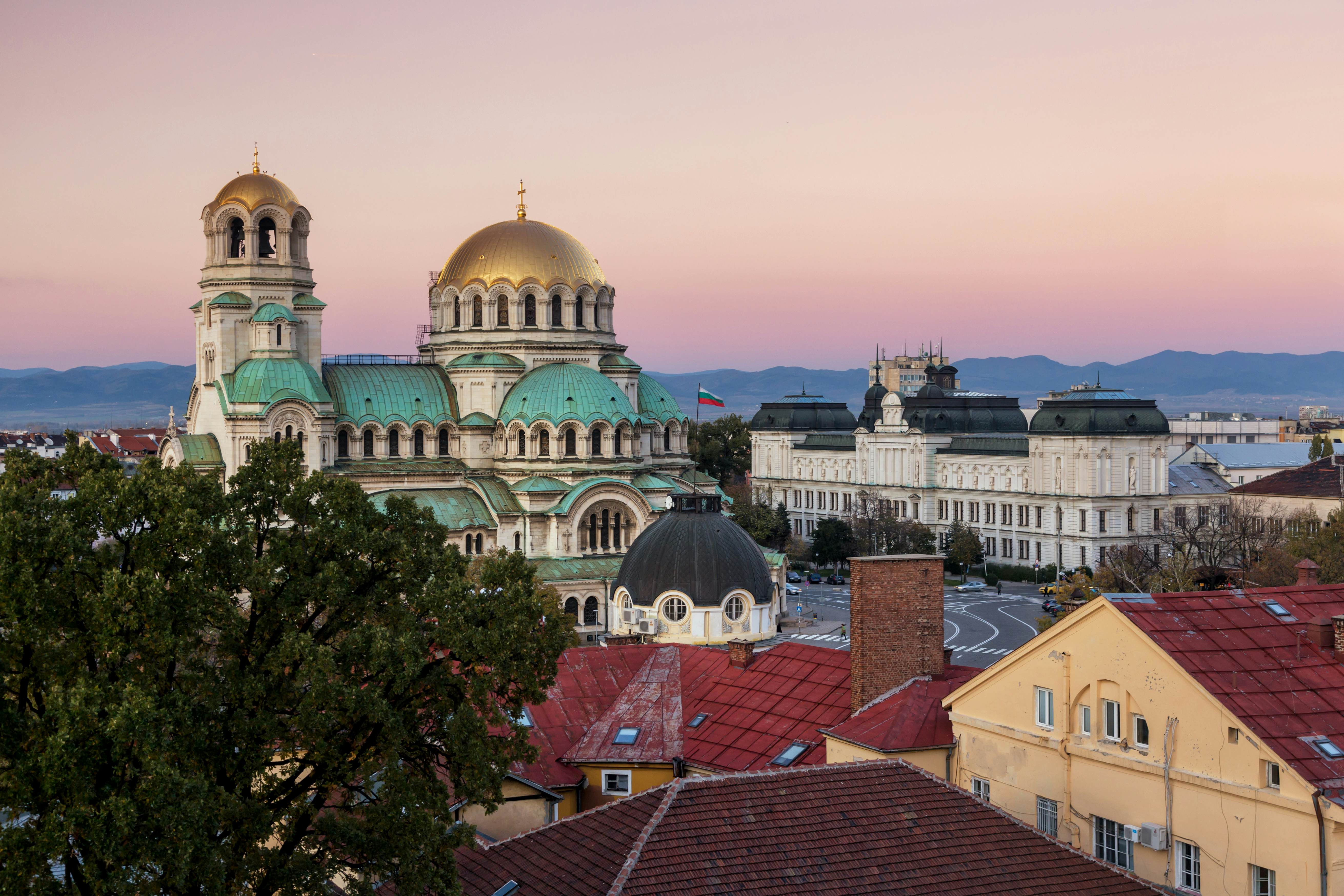 A gold-domed church building at sunset.