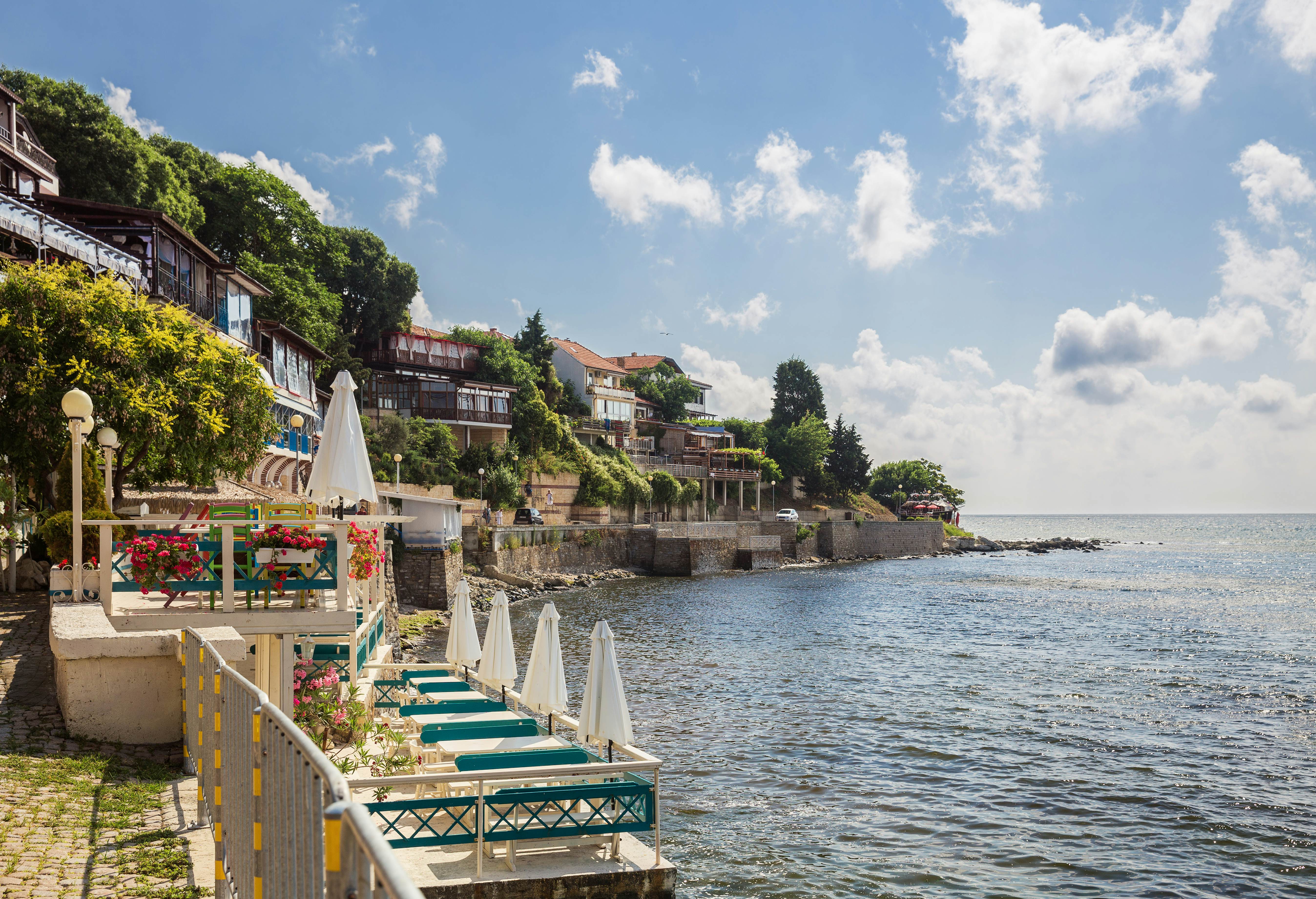 Cafe terraces at the edge of the sea on a sunny day