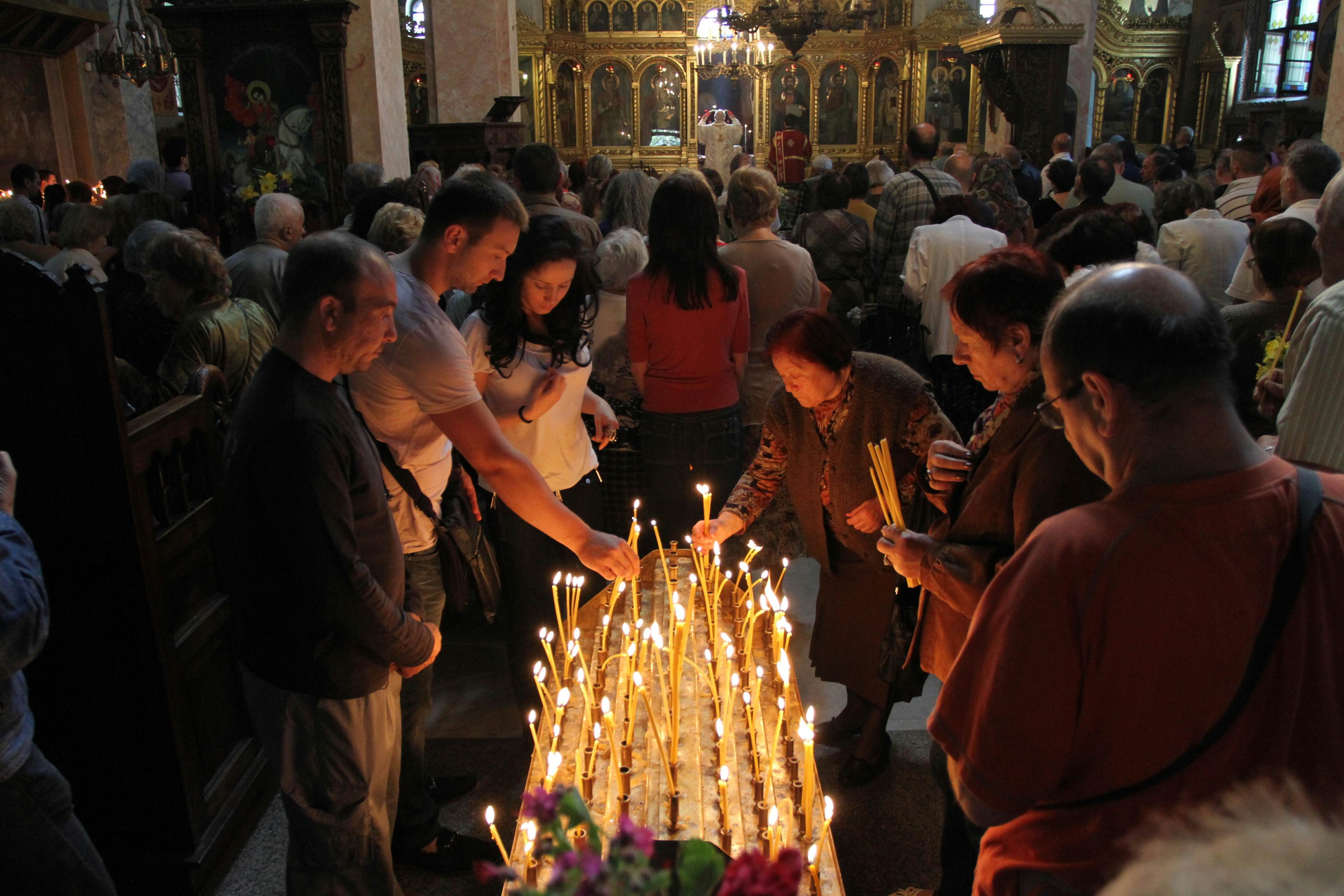 People light candles in Saint George Church in Sofia, Bulgaria.