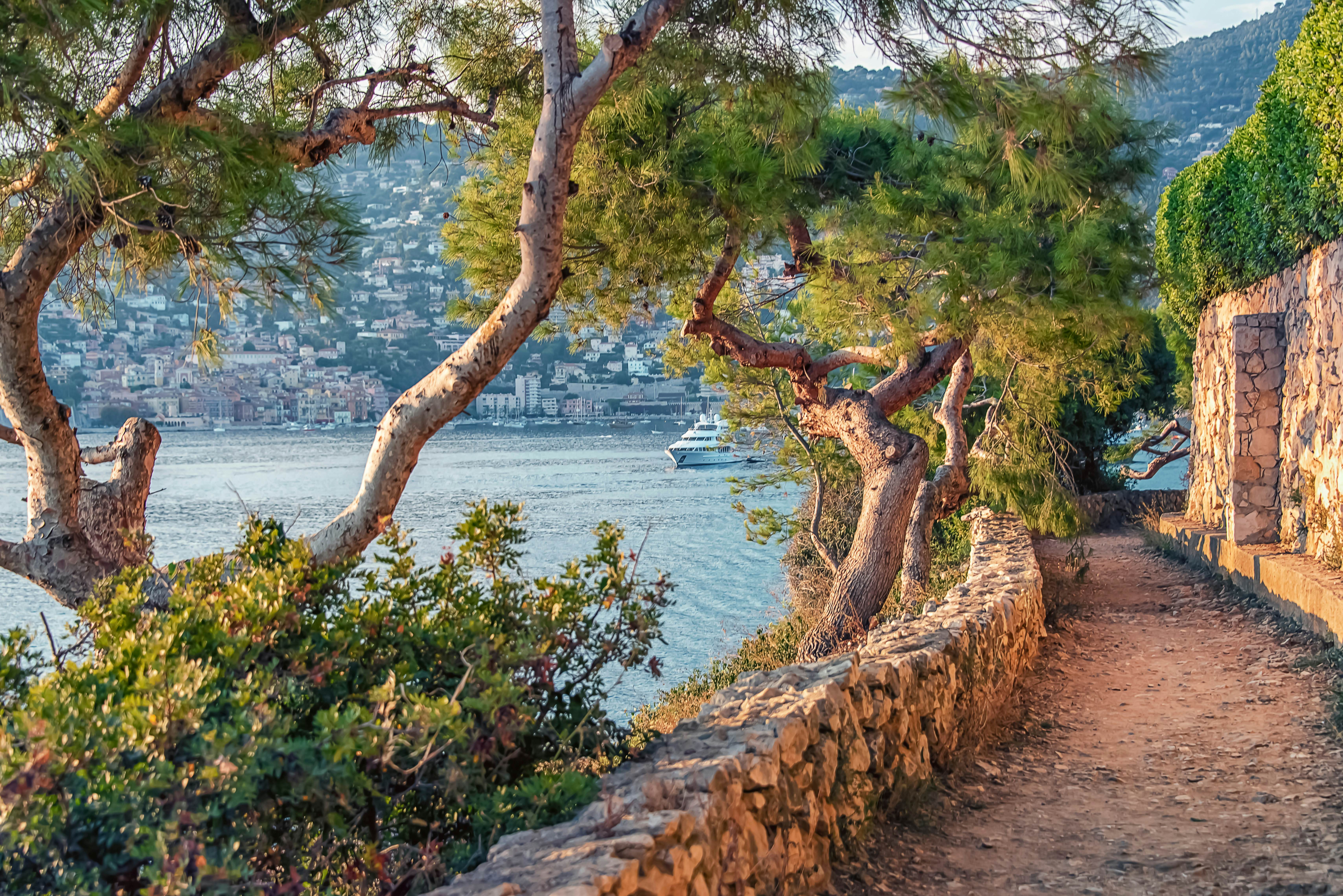 Dirt track and trees by the water Villefranche-Sur-Mer Village on the French Riviera.