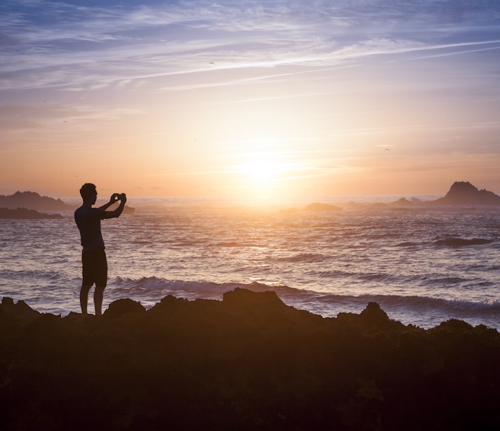 Young adult taking photo of amazing sunset light on the beach, License Type: media, Download Time: 2025-03-11T10:15:54.000Z, User: joebindloss38, Editorial: false, purchase_order: 65050 - Digital Destinations and Articles, job: Online Editorial, client: How to get your cell phone connected in Morocco: eSIMs, wi-fi and mobile networks, other: Joe Bindloss