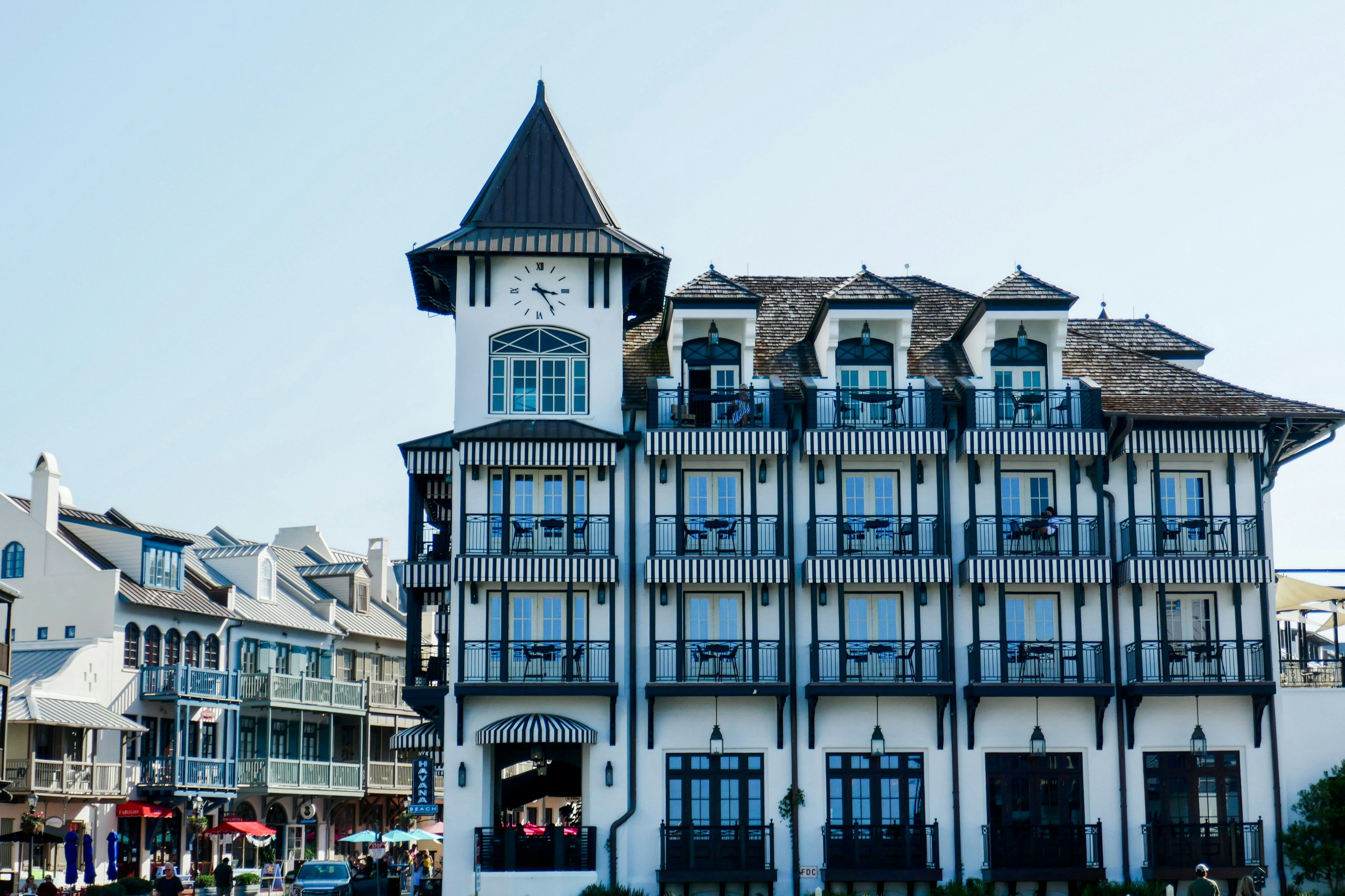 A blue and white Dutch-style building with a clock in a turret in Florida.