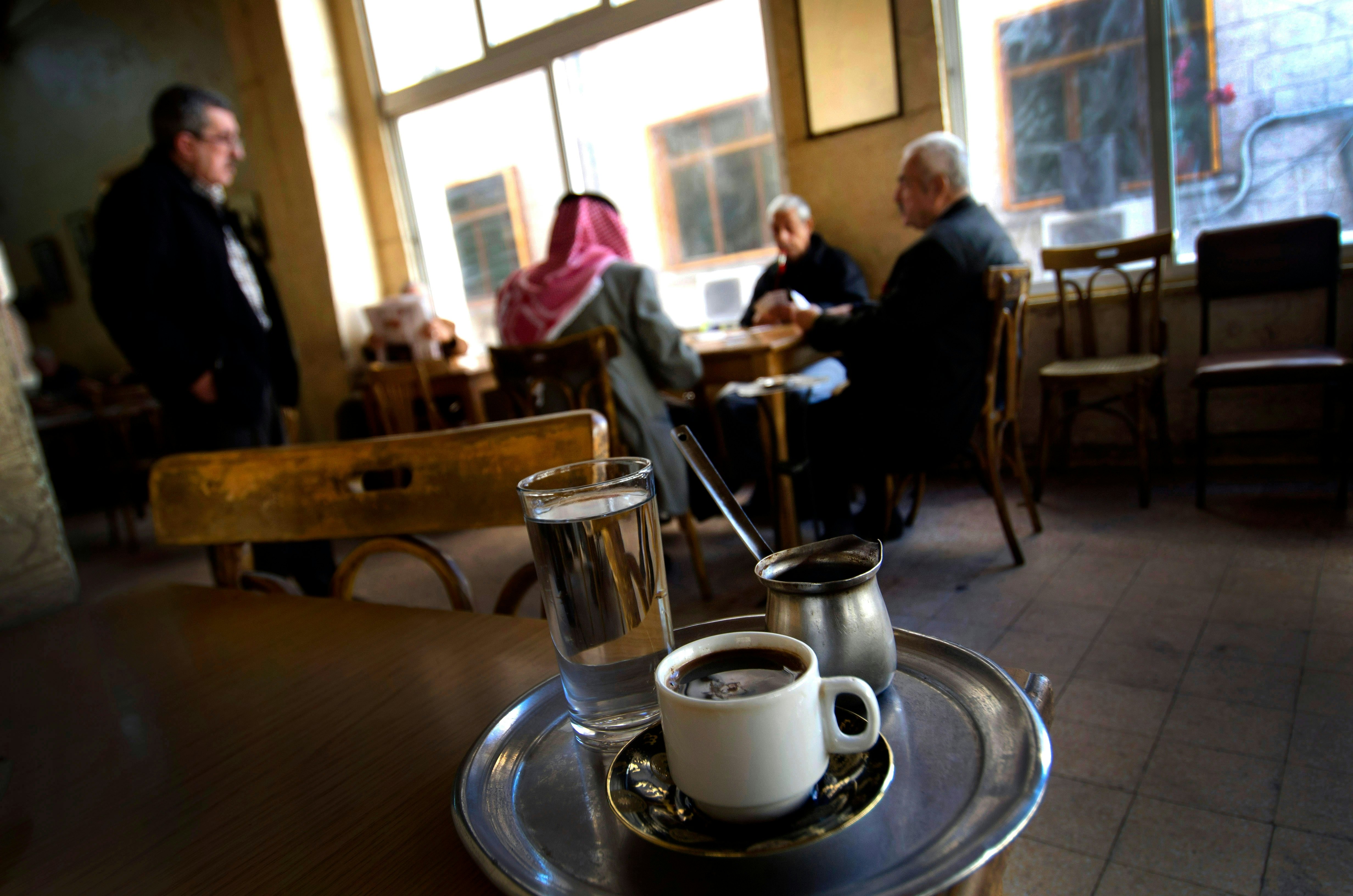 Traditional pot of Arabic coffee on a tray in a typical local coffee shop in Downtown Amman, Jordan. ,