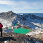 View with a couple of hikers at beautiful Emerald lakes on Tongariro Crossing track, Tongariro National Park, New Zealand; Shutterstock ID 386815264; purchase_order:65050 - Digital Destinations and Articles; job:Online editorial; client:Tongariro Crossing guide; other:Claire Naylor
386815264