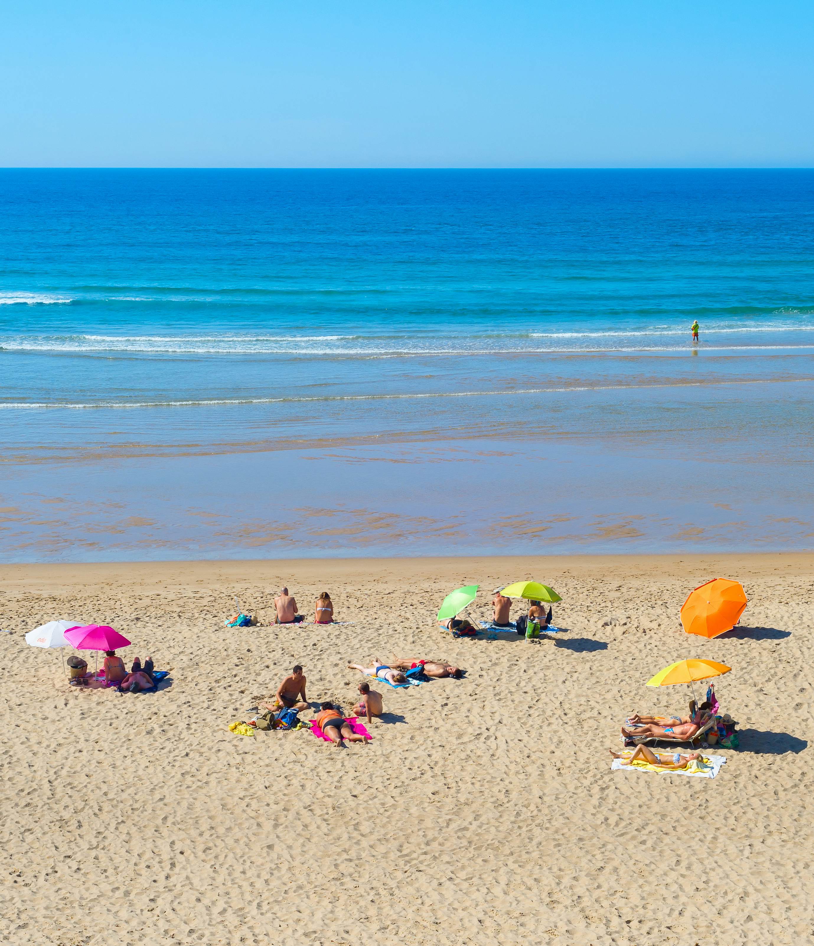 People at the beach on a summer sunny day in Odeceixe, Portugal.