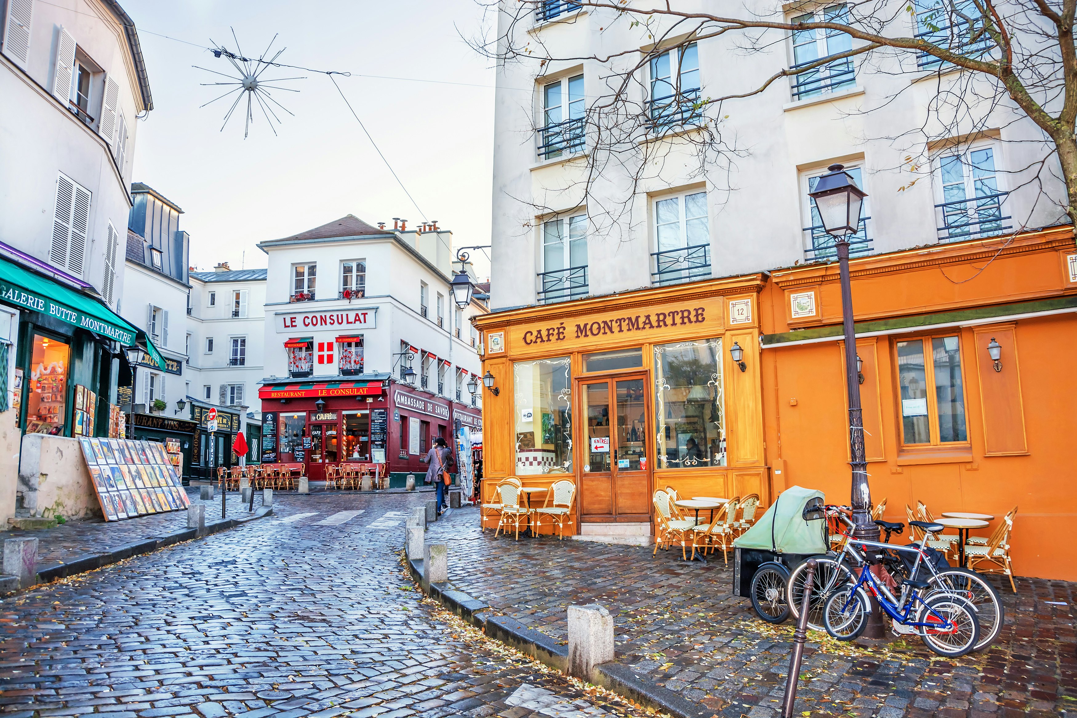 A French street in the Montmartre district with small cafes, restaurants and art galleries.