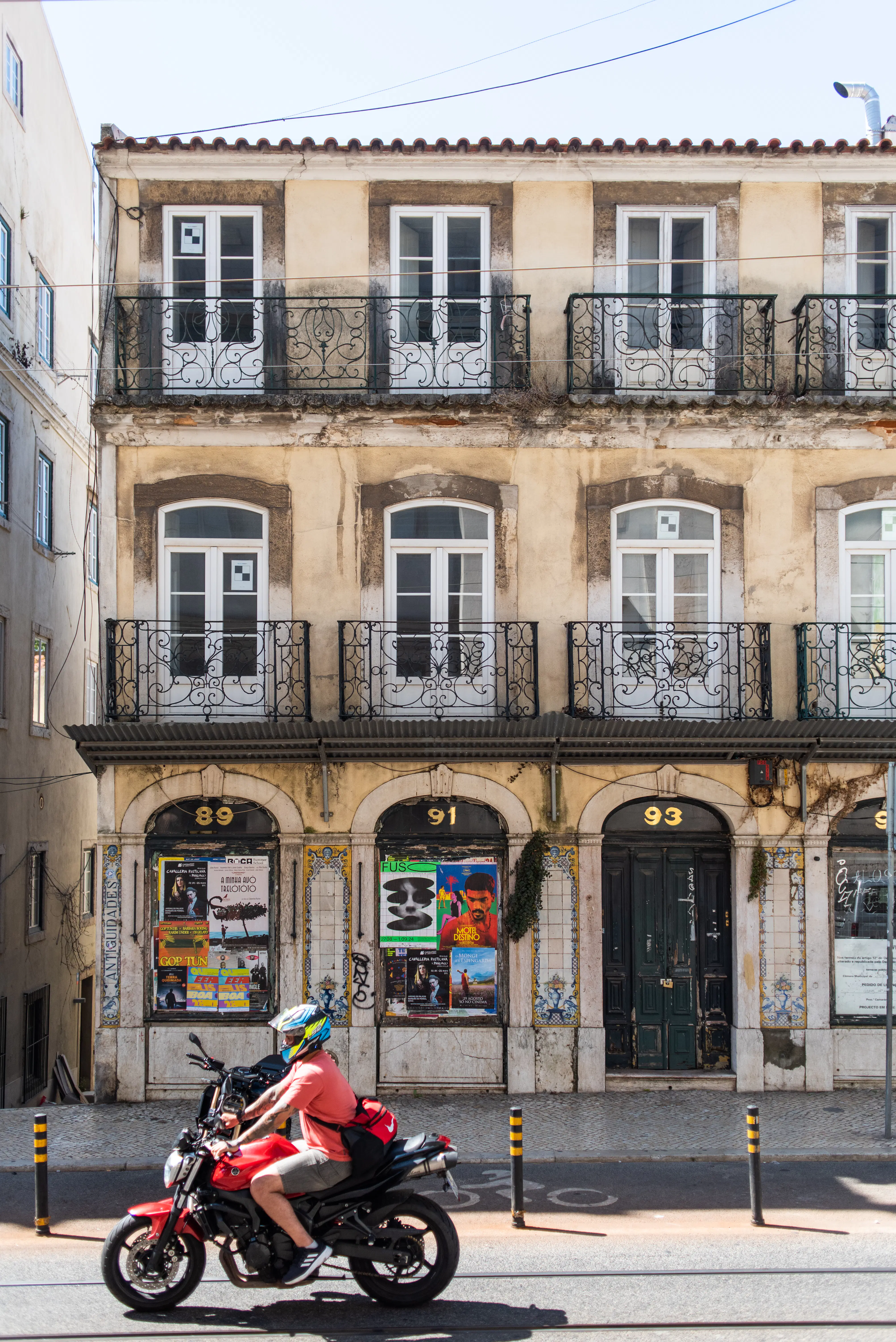 A motorcycle travels through a city neighborhood