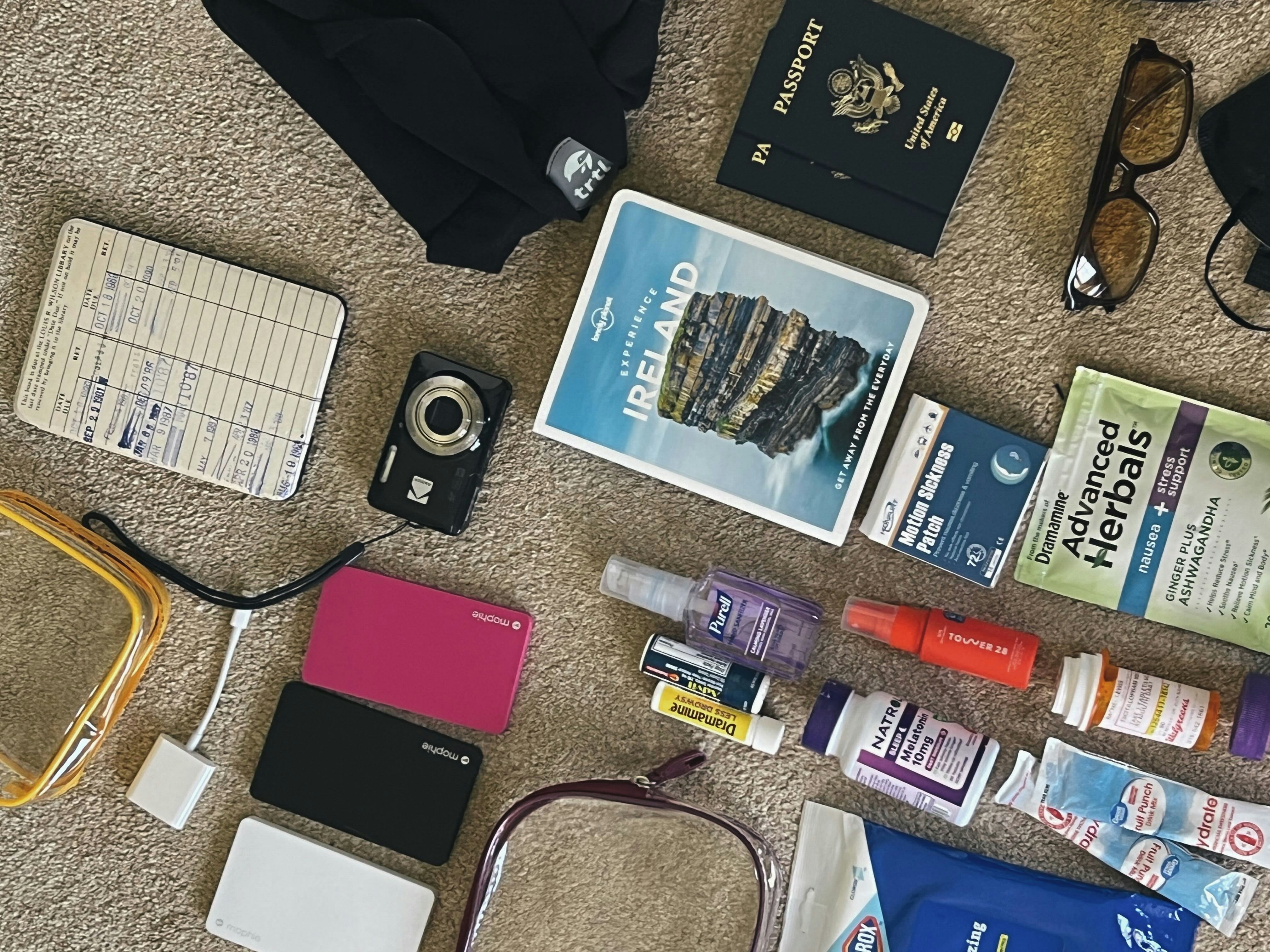 Must-have items for a plane ride, including passport, medication, chargers, etc.
