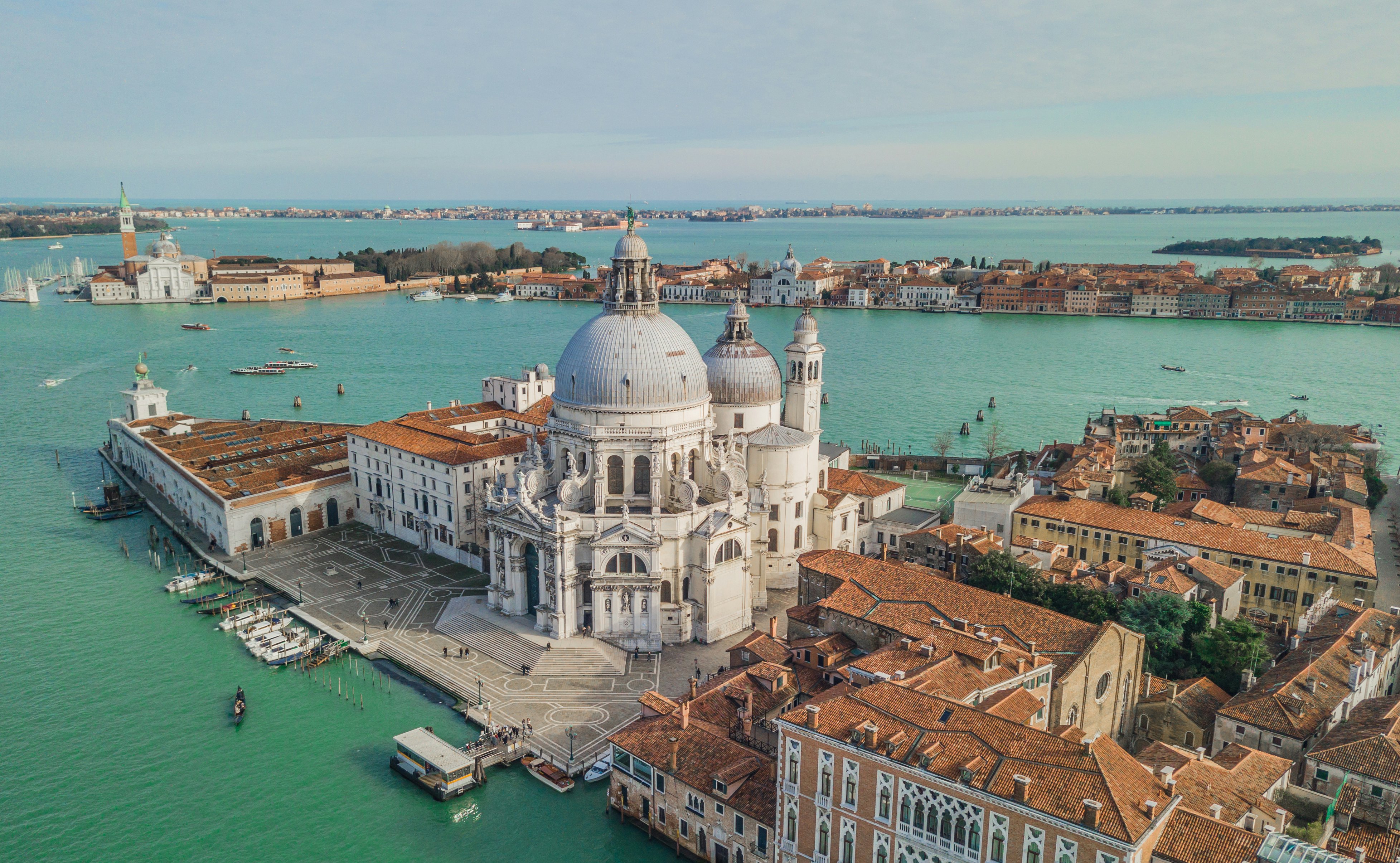 A large domed church on a narrow peninsula surrounded by water.
