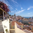 Lisbon / Portugal: 10 August 2020: Miradouro de Santa Luzia, an observation deck with a pergola offering dramatic views of Lisbon & the Tagus River  License Type: media  Download Time: 2022-12-01T23:34:22.000Z  User: mvm_lonelyplanet  Is Editorial: Yes  purchase_order: