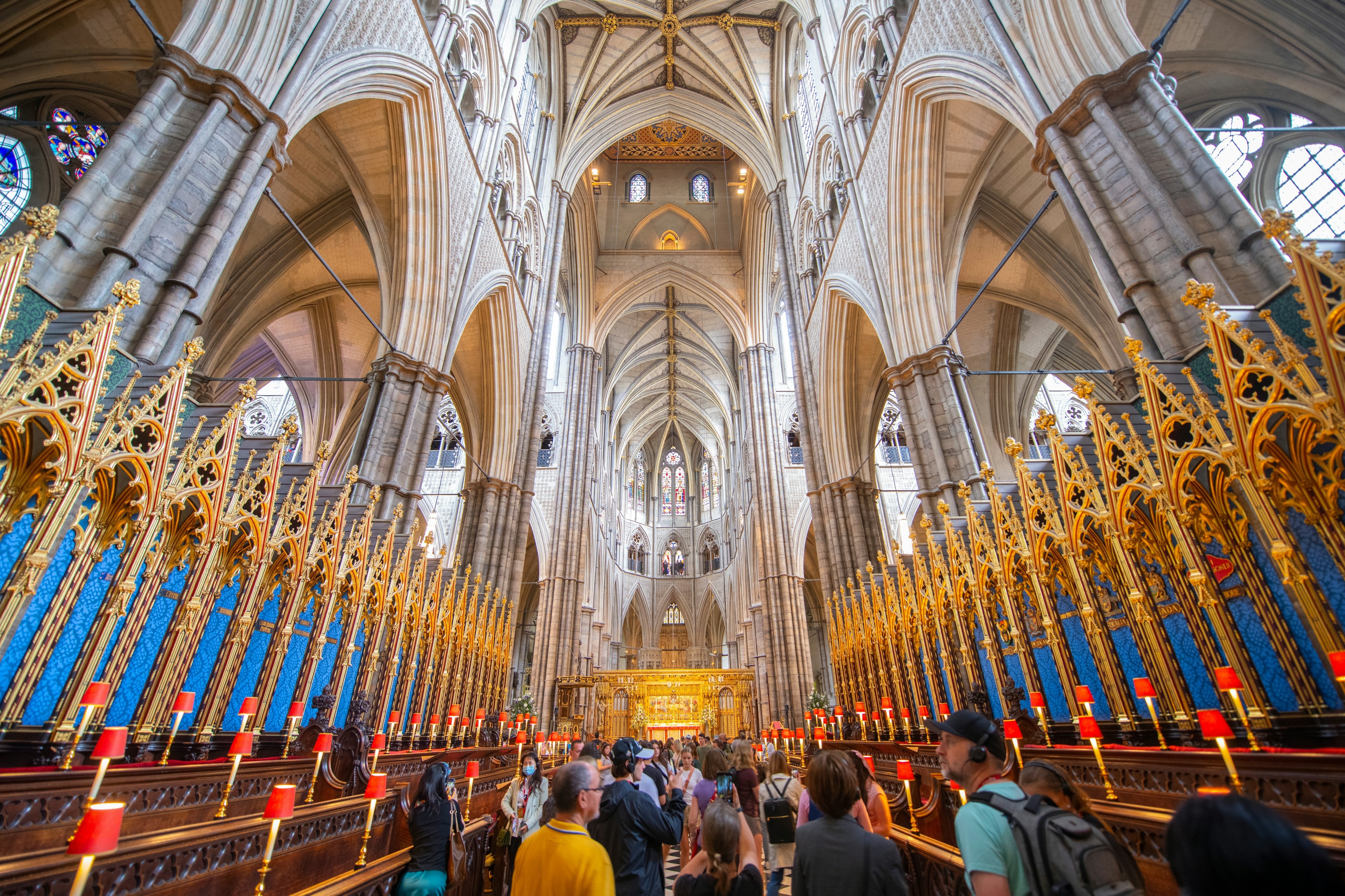 Tourists in a vast Gothic abbey