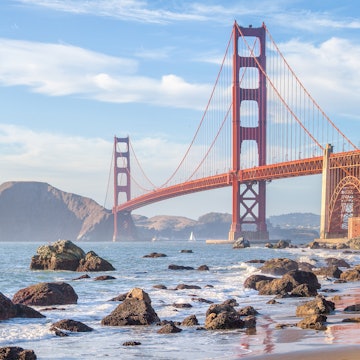 Classic panoramic view of famous Golden Gate Bridge seen from scenic Baker Beach in beautiful golden evening light on a sunny day with blue sky and clouds in summer, San Francisco, California, USA License Type: media Download Time: 2021-08-23T02:27:27.000Z User: mvm_lonelyplanet Is Editorial: No purchase_order:
