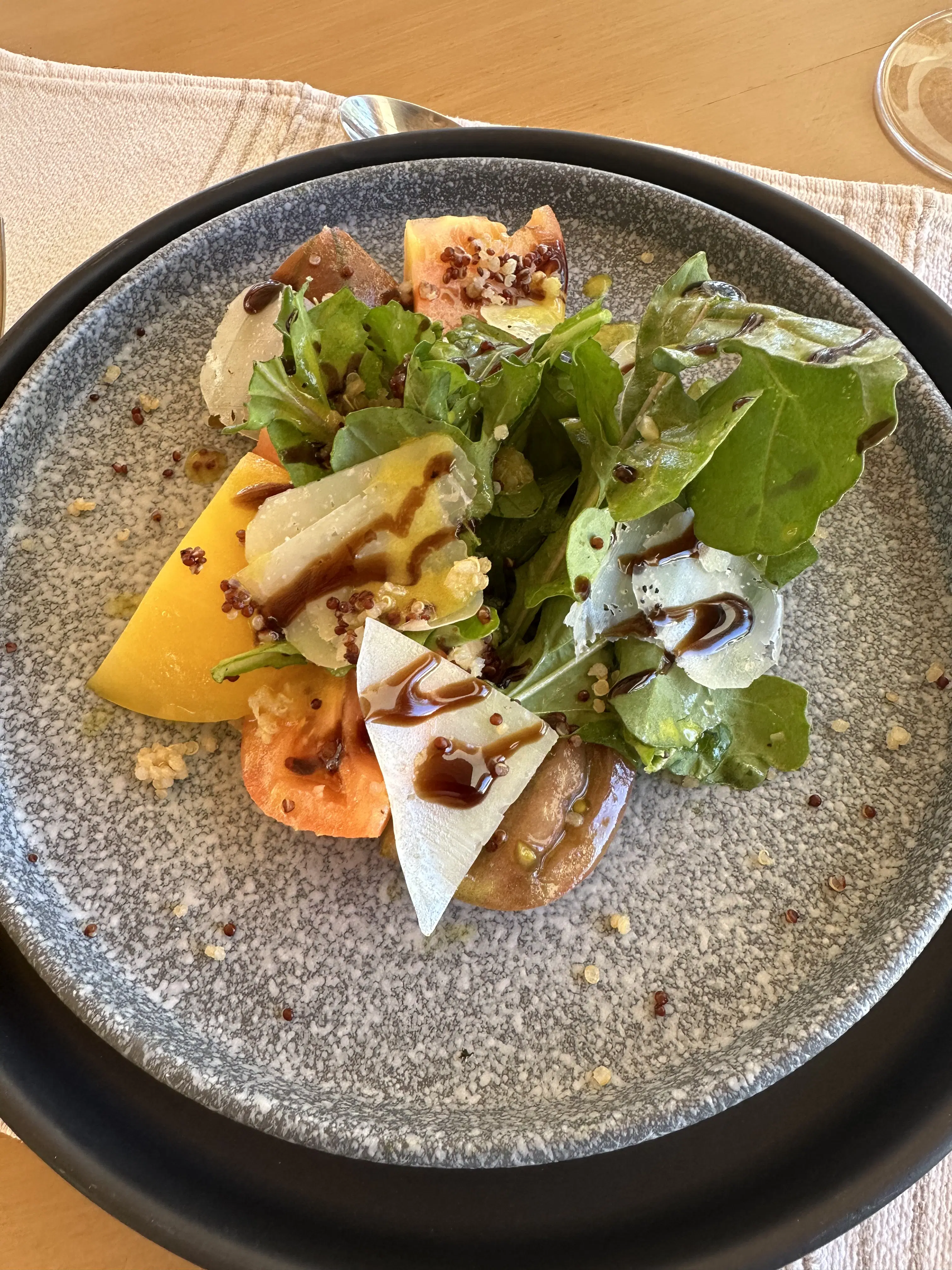 Plated salad served on grey dish.