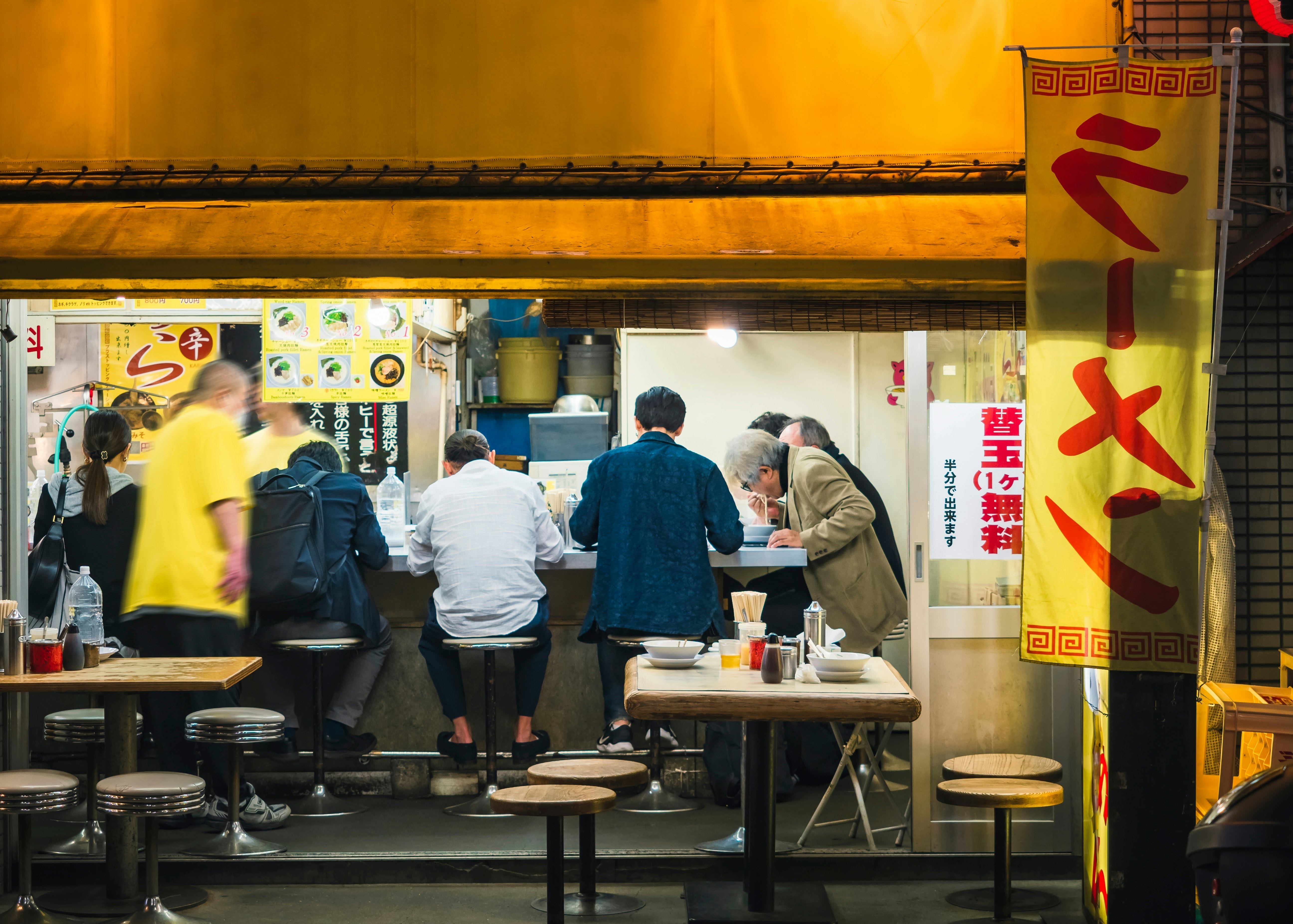 Ramen shop Counter bar Japanese noodle shop with people eating. Tokyo city nightlife.