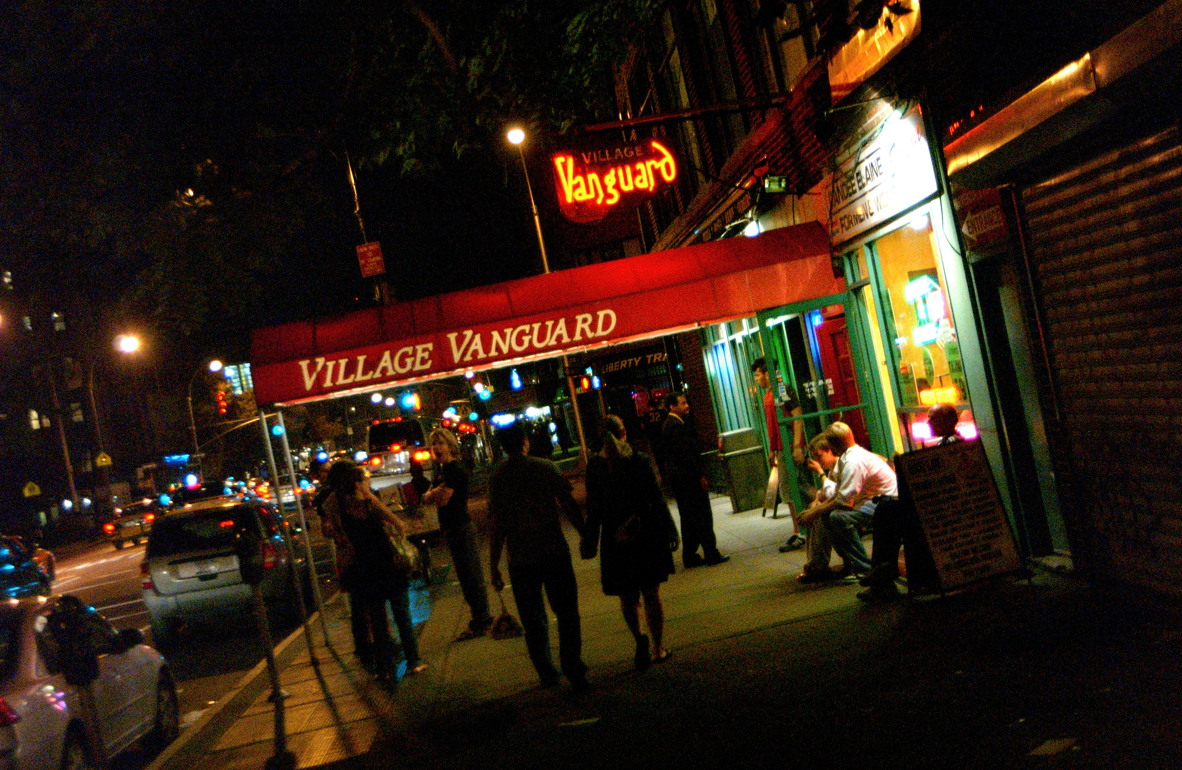 People mingling outside the Village Vanguard at night in the West Village
