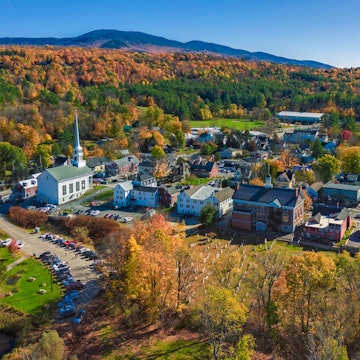 Aerial view of charming small town Stowe in Vermont. Mountains with fall multicolor trees License Type: media Download Time: 2022-07-28T16:14:45.000Z User: Is Editorial: No purchase_order: