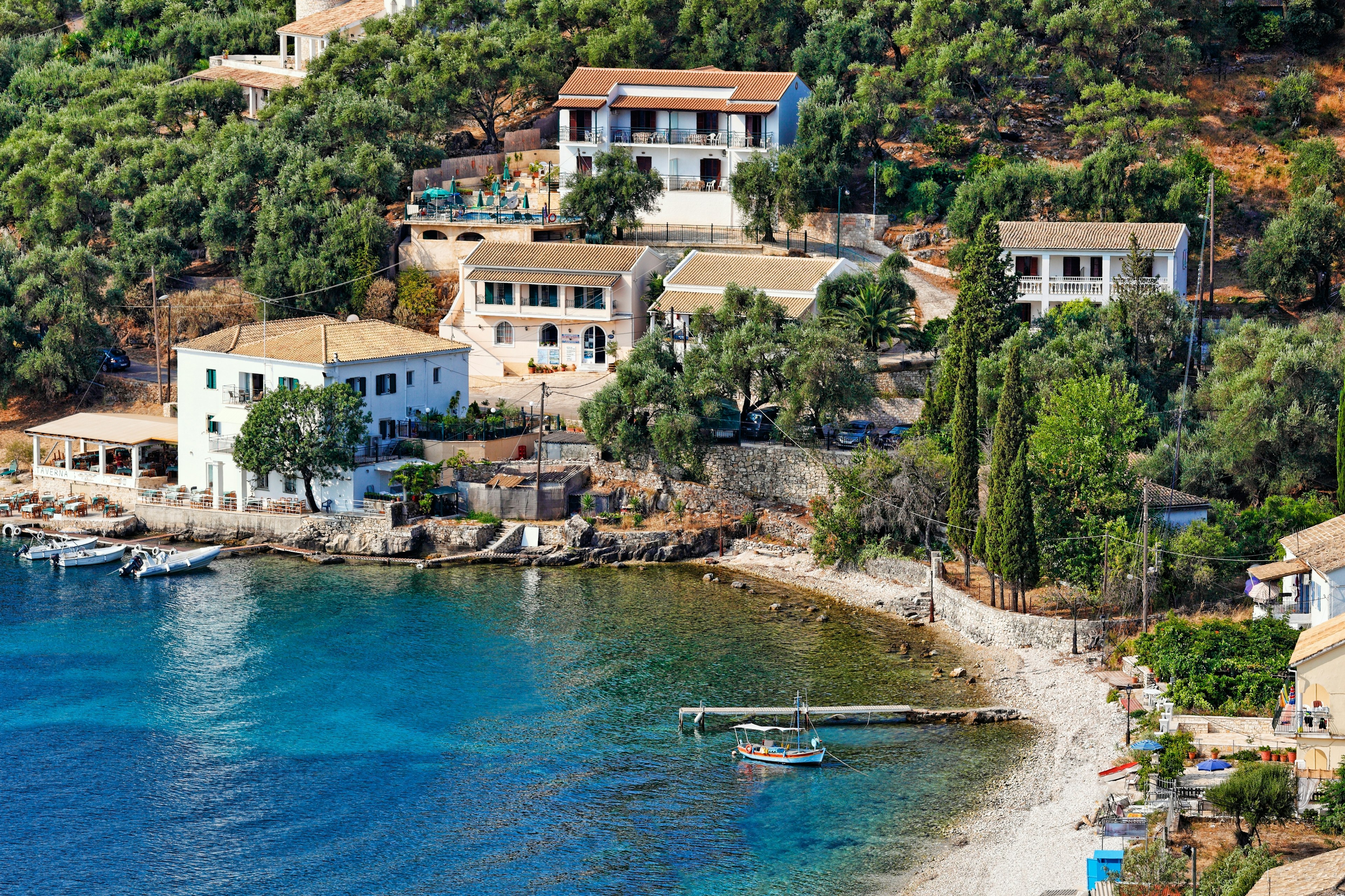 Whitewashed buildings overlooking a pebble beach