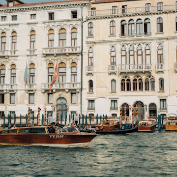 Venice, Italy - 7 October 2022: Water taxi cruising past Palazzo Ferro Fini, a luxury Hotel, License Type: media, Download Time: 2025-04-04T19:34:06.000Z, User: rhylton_redventures, Editorial: true, purchase_order: 65050 - Digital Destinations and Articles, job: Lonely Planet , client: app wip, other: Rhianydd Hylton