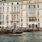 Venice, Italy - 7 October 2022: Water taxi cruising past Palazzo Ferro Fini, a luxury Hotel, License Type: media, Download Time: 2025-04-04T19:34:06.000Z, User: rhylton_redventures, Editorial: true, purchase_order: 65050 - Digital Destinations and Articles, job: Lonely Planet , client: app wip, other: Rhianydd Hylton