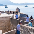 Dubrovnik, Croatia, August 21st, 2024: Visitors stroll along the historic Dubrovnik city walls with panoramic views of the Adriatic Sea., License Type: media, Download Time: 2025-04-10T19:39:59.000Z, User: rhylton_redventures, Editorial: true, purchase_order: 65050 - Digital Destinations and Articles, job: Lonely Planet, client: app wip, other: Rhianydd Hylton