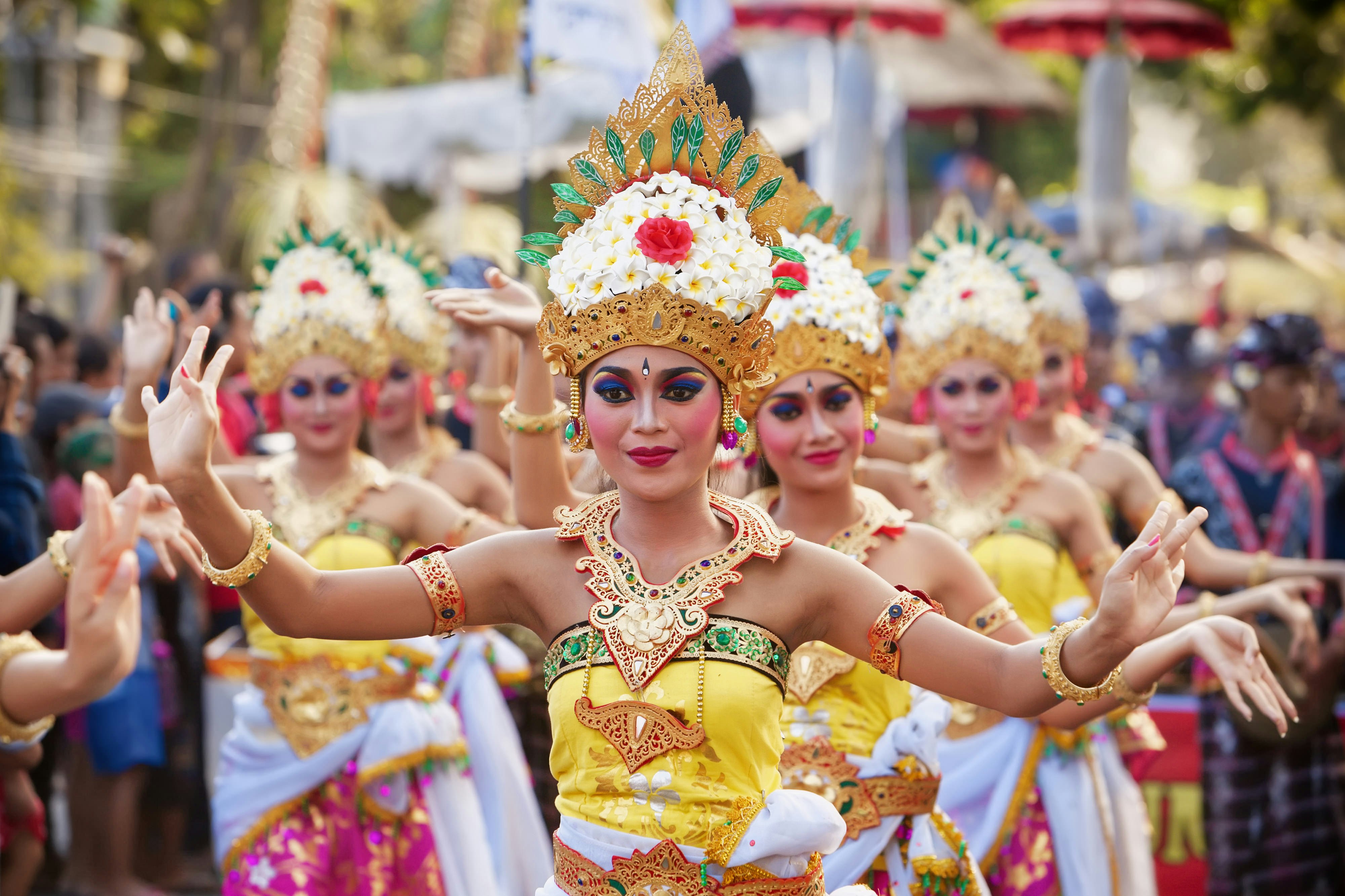 Dancers in elaborate costumes with headdresses.