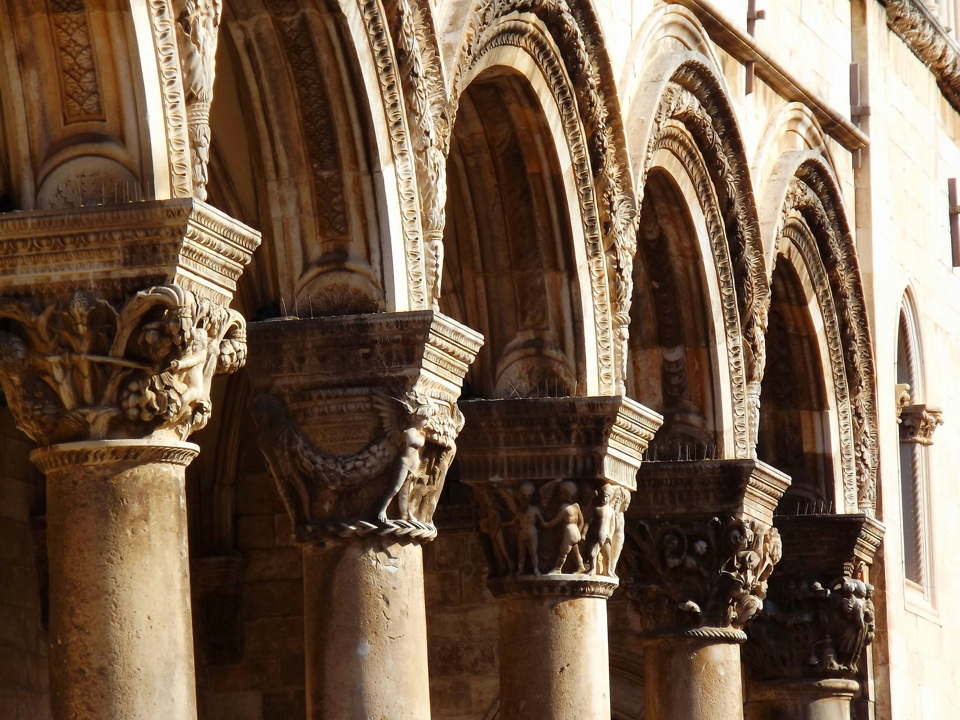 Carvings on the pillars and archways of the facade at Rector's Palace in Dubrovnik.