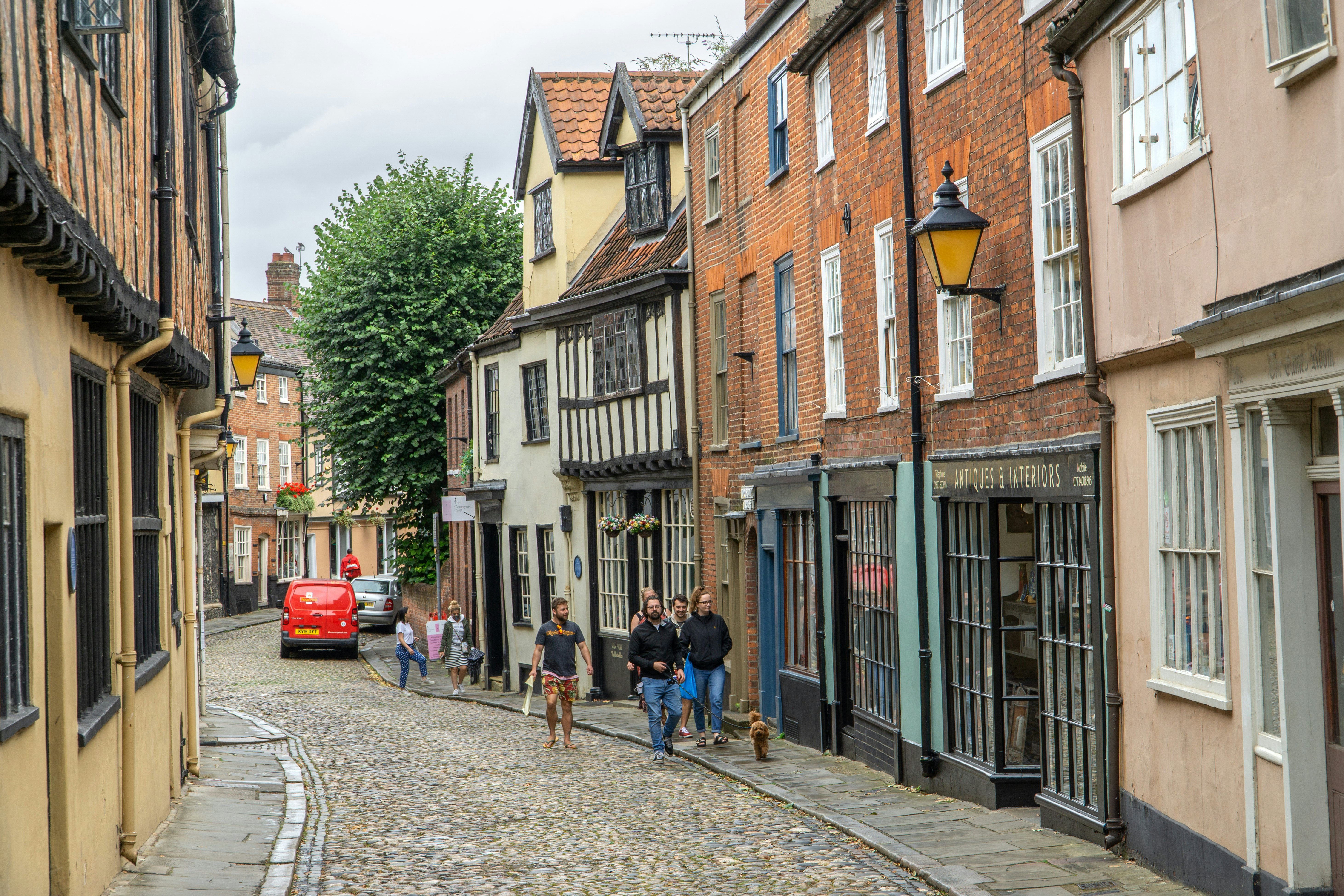 A historic cobbled lane with many buildings dating back to the Tudor period in Norwich, England.