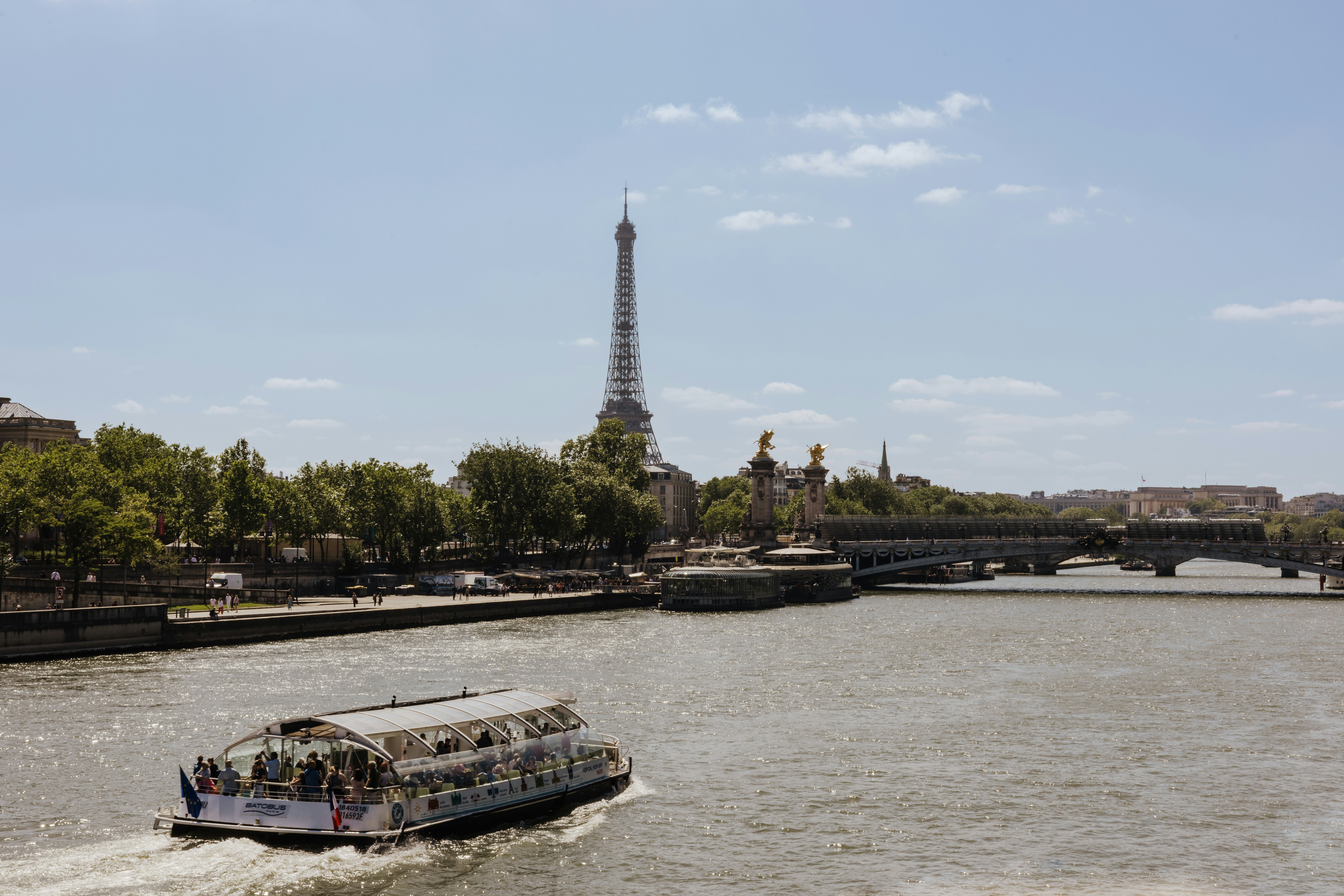A glass-roof cruise along the River Seine with the Eiffel Tower in the background