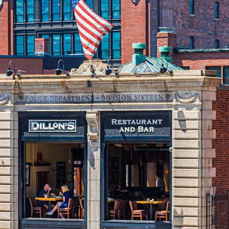 Open windows into a restaurant with Dillon's Restaurant and Bar on the sign