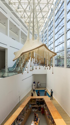 An art installation hangs from the ceiling of a modern museum building in Buenos Aires.