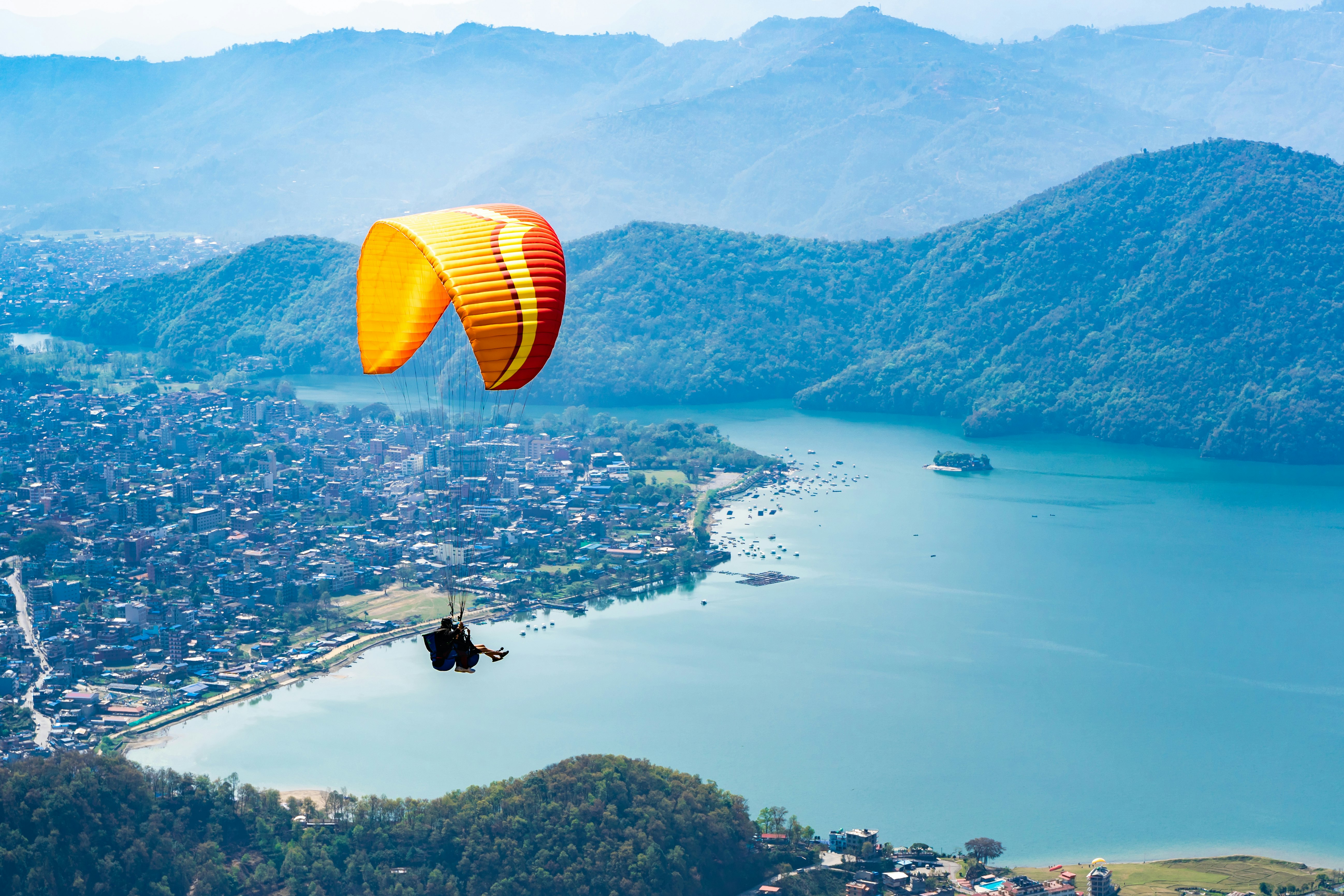 Paraglider on the background of Phewa Lake, Pokhara City and surrounding villages