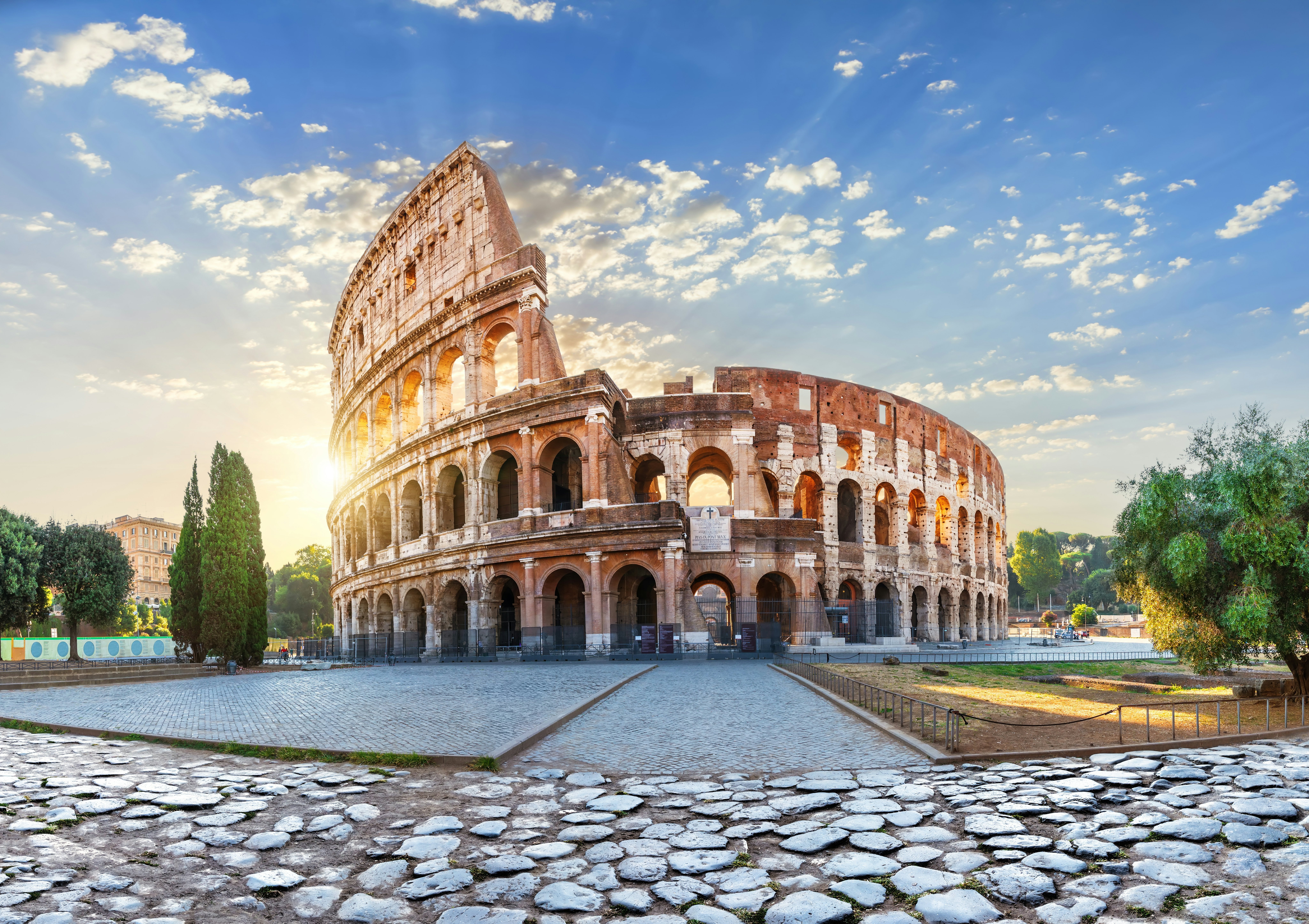 The ruins of an ancient amphitheater glow in the morning sunshine.