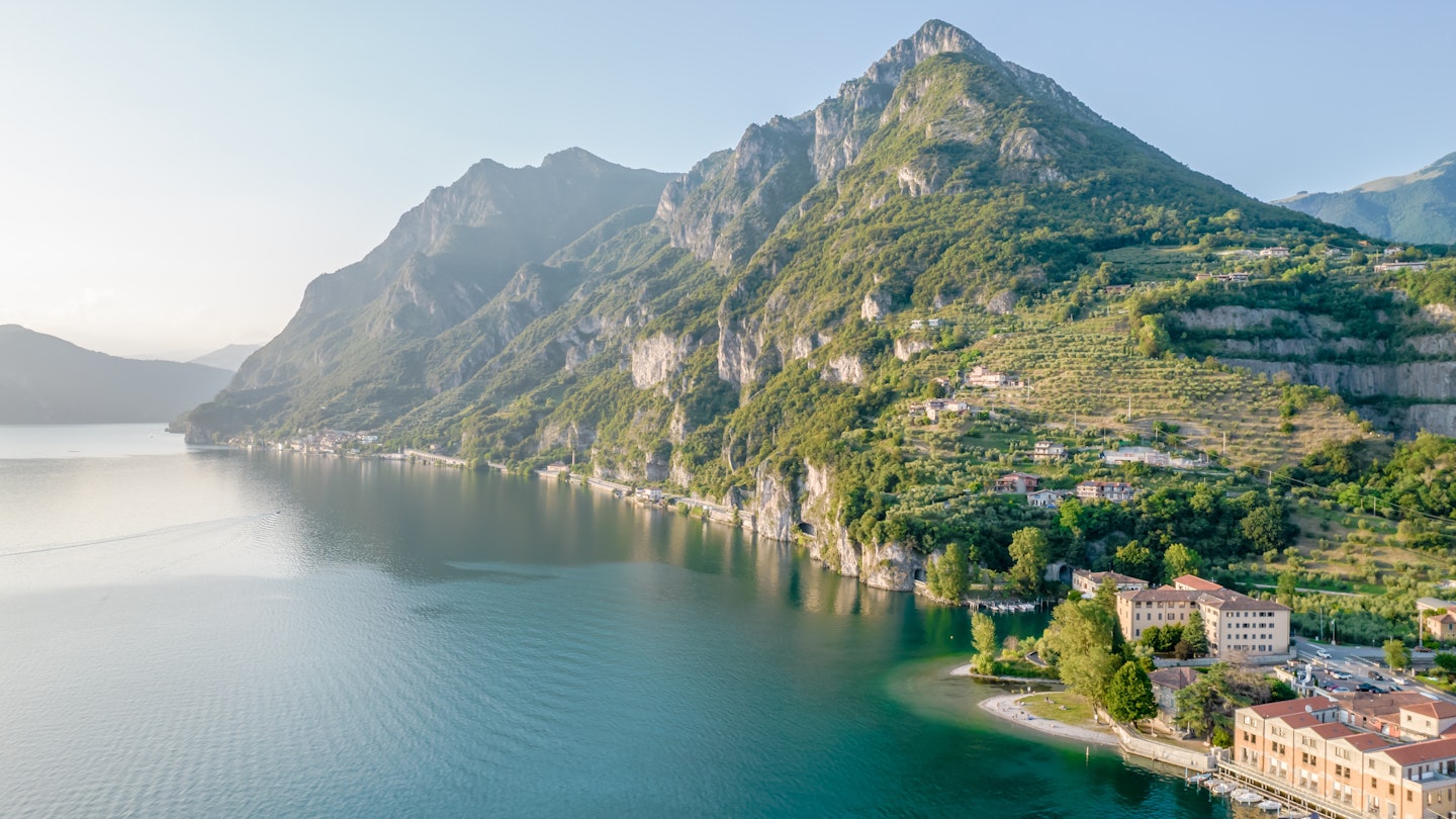 Marone, Lake Iseo. Aerial panoramic sunset view of Marone town surrounded by mountains and located in Iseo Lake, Brescia, Lombardy, Italy, License Type: media, Download Time: 2025-06-23T16:58:15.000Z, User: adouglaslott59, Editorial: false, purchase_order: 65050 - Digital Destinations and Articles, job: Online editorial, client: Lago d'Iseo guide, other: Ann Douglas Lott