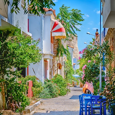 Colorful flower-filled street lined with beautiful old houses