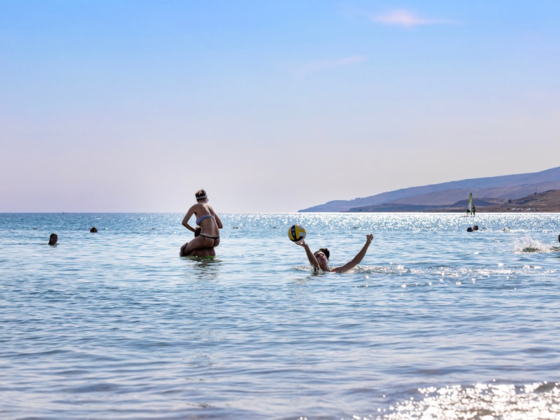 Group of cheerful friends playing in the sea.