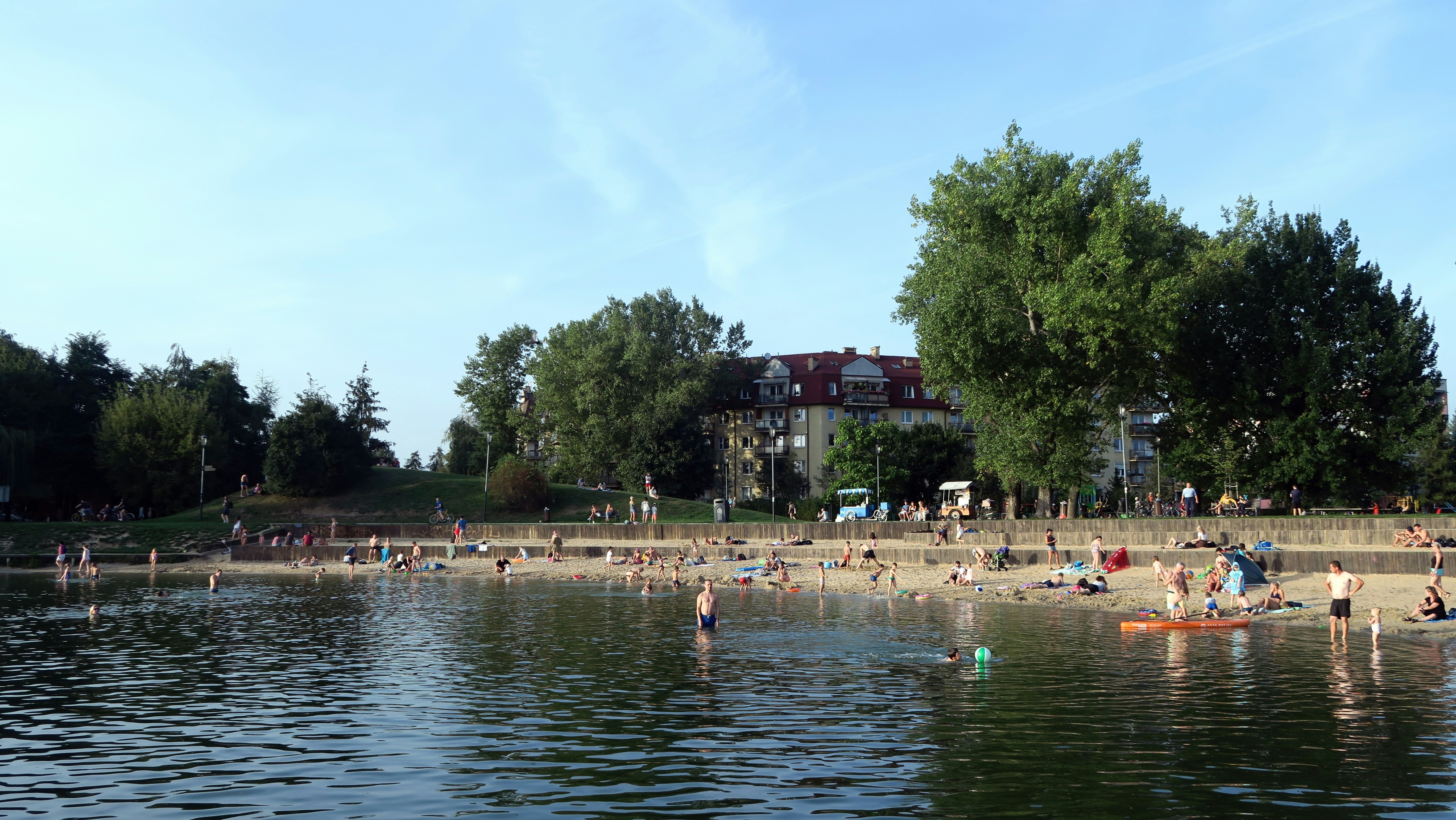 People wading in water and sunbathing on a beach at a lake in °°ù²¹°ìó·É.