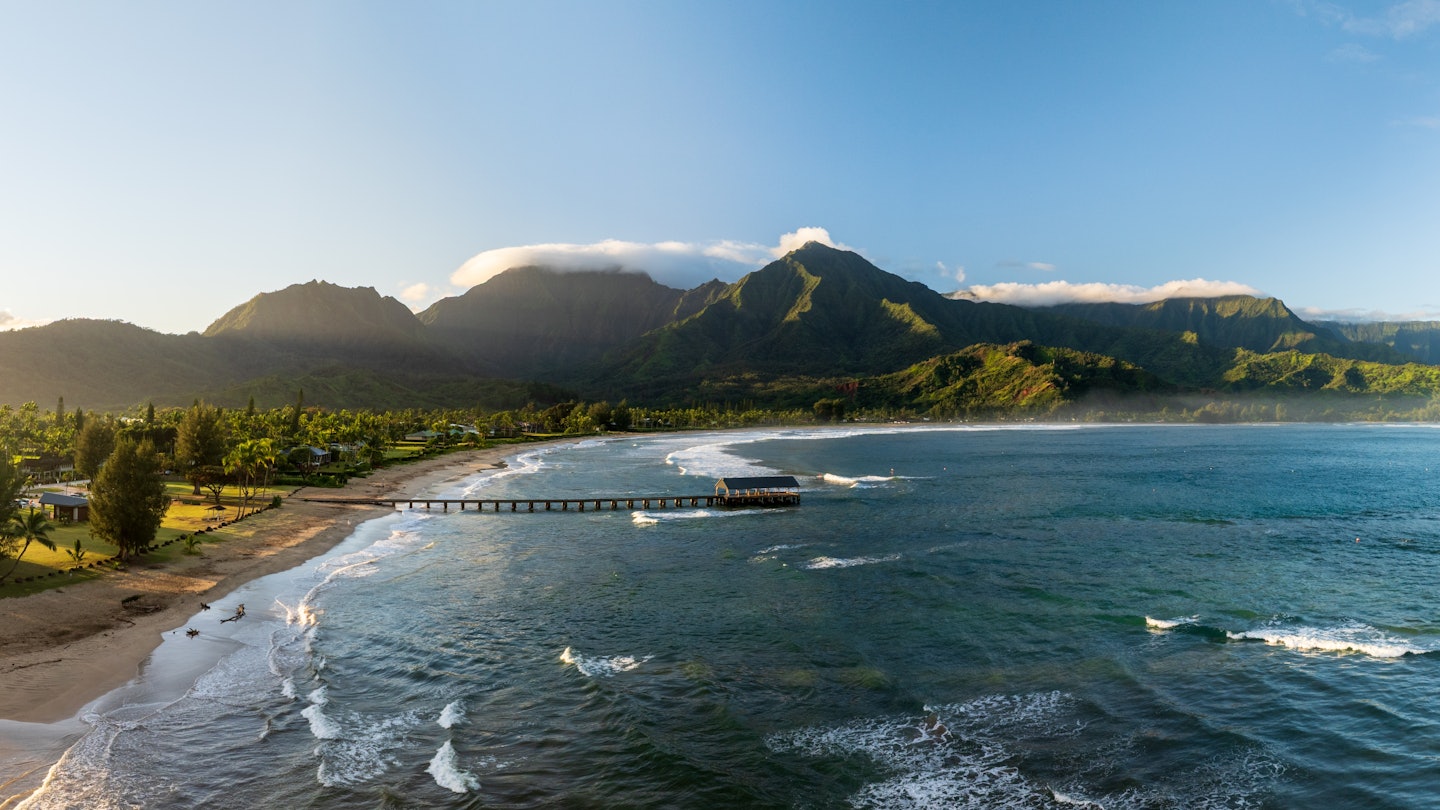 Aerial panoramic image at sunrise off the coast over Hanalei Bay and pier on Hawaiian island of Kauai, License Type: media, Download Time: 2025-03-18T00:09:57.000Z, User: katelyn.perry_lonelyplanet, Editorial: false, purchase_order: 65050 - Digital Destinations and Articles, job: wip, client: wip, other: Katelyn Perry