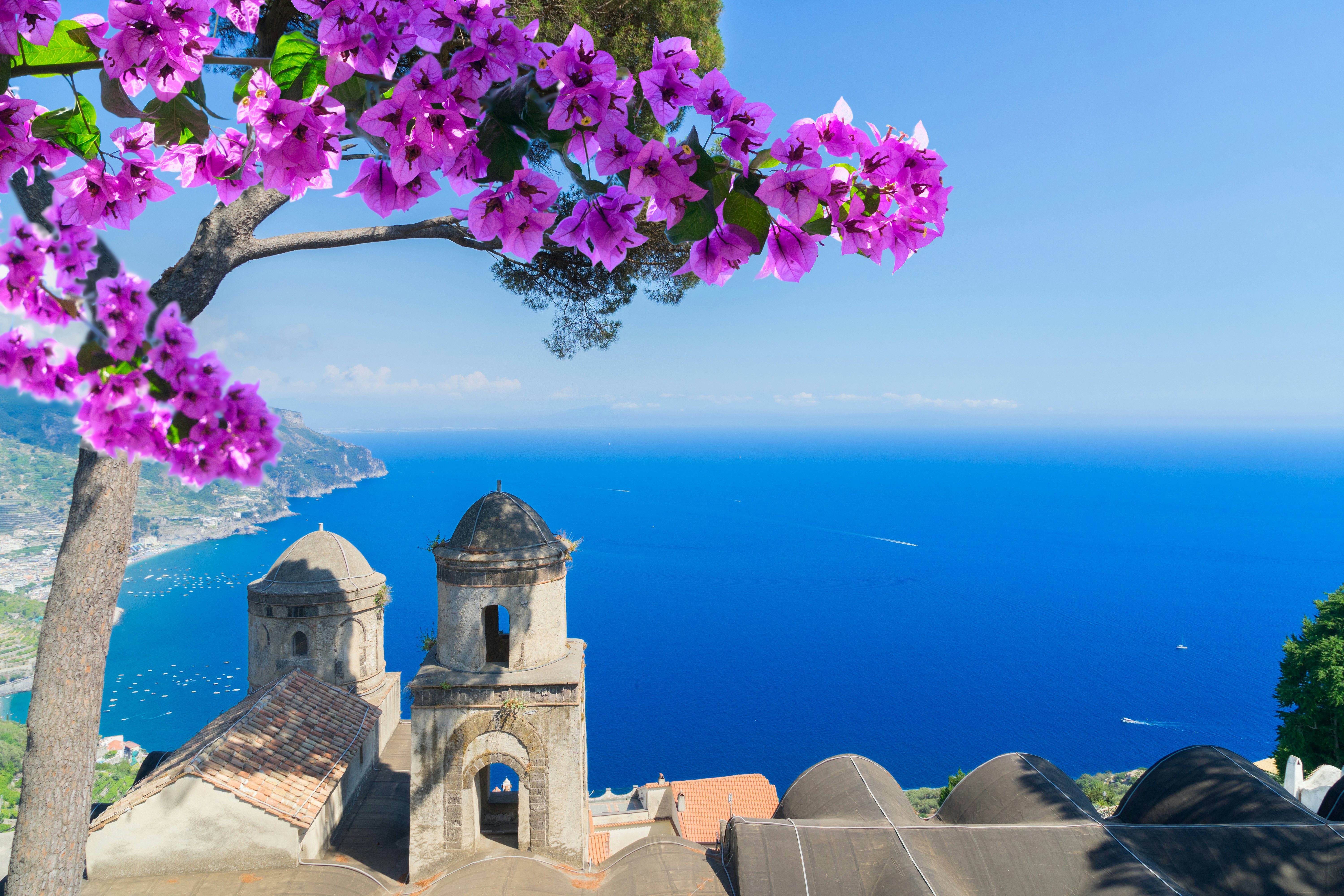 Church bell towers on a high vantage point in a coastal village with views along the rugged coastline.