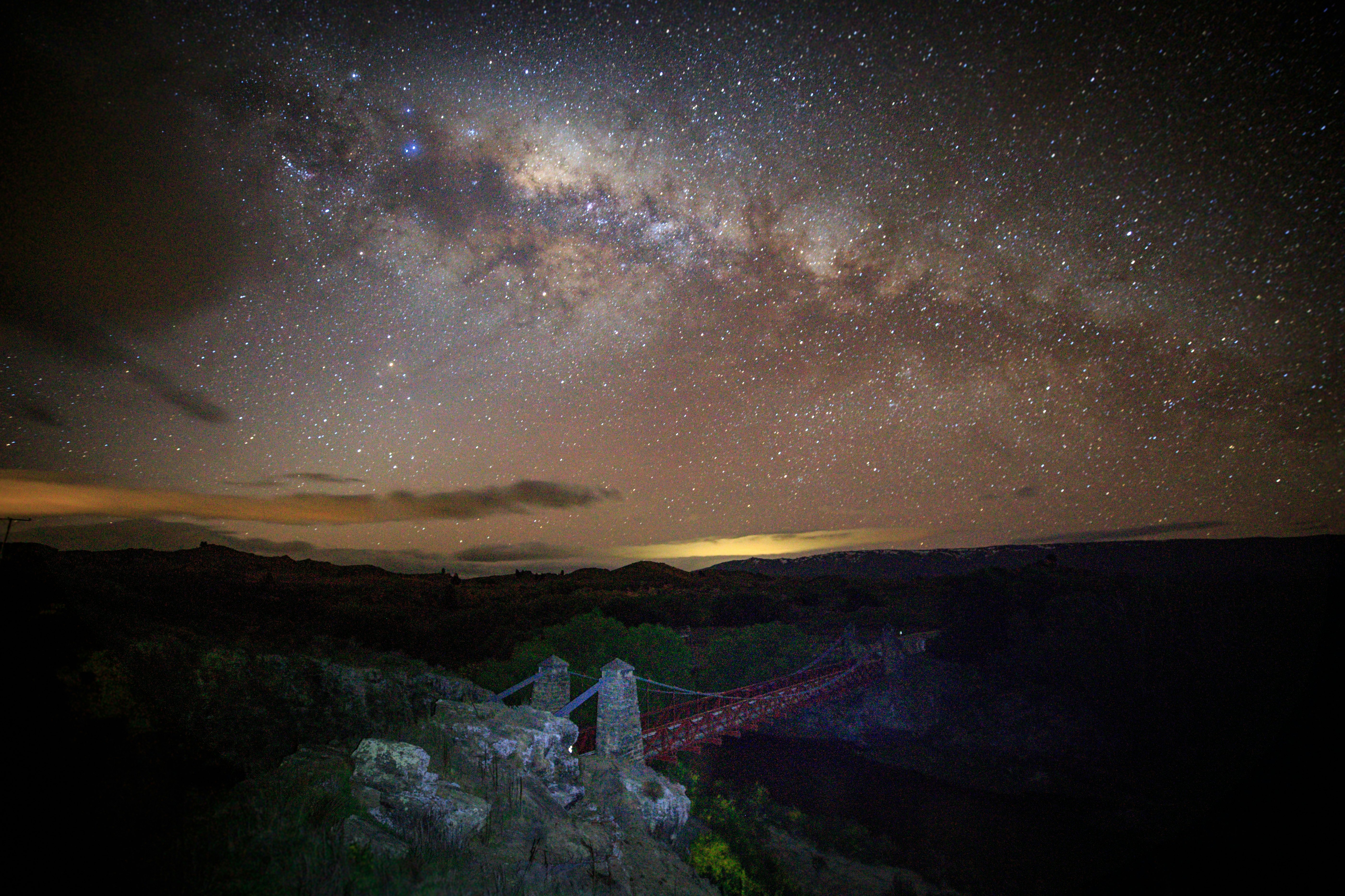 A glow in the sky on the horizon gives way to a galaxy full of stars.